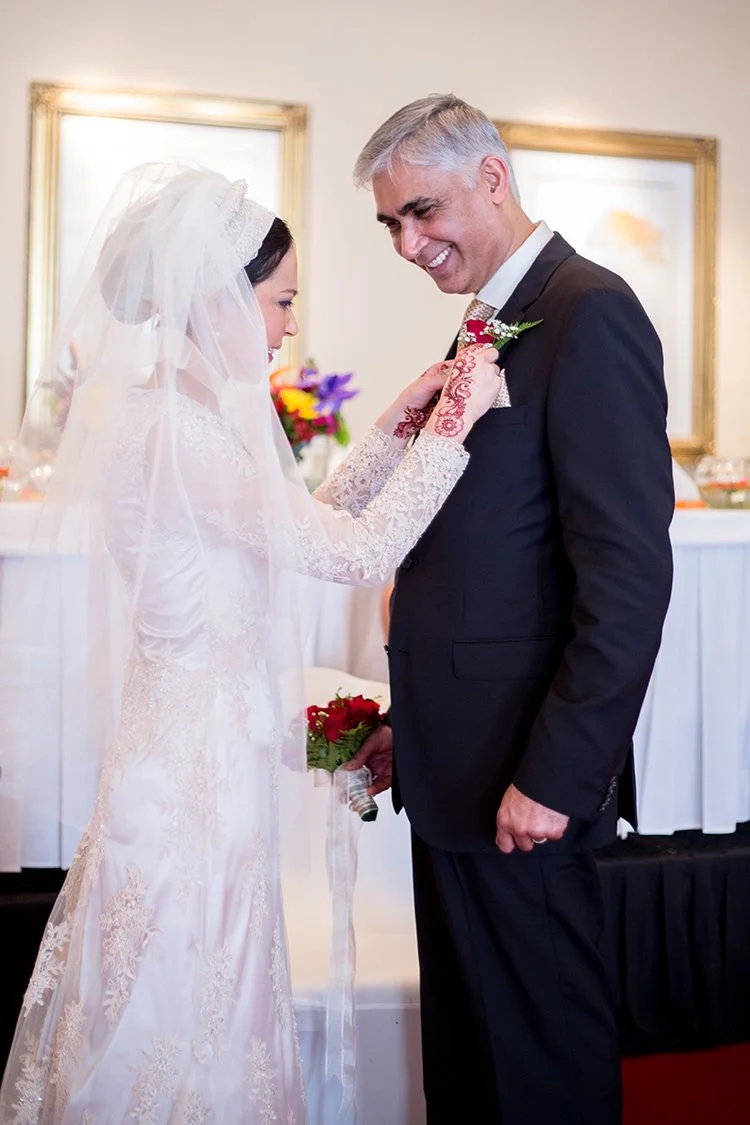 Hindu bride adjusting garland on groom at Hindu wedding