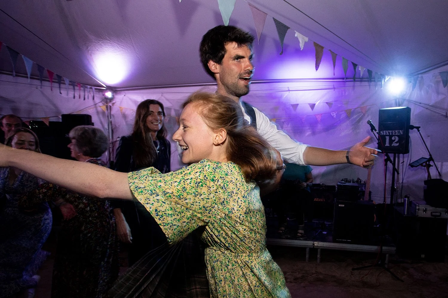 groom dancing with guest at wedding