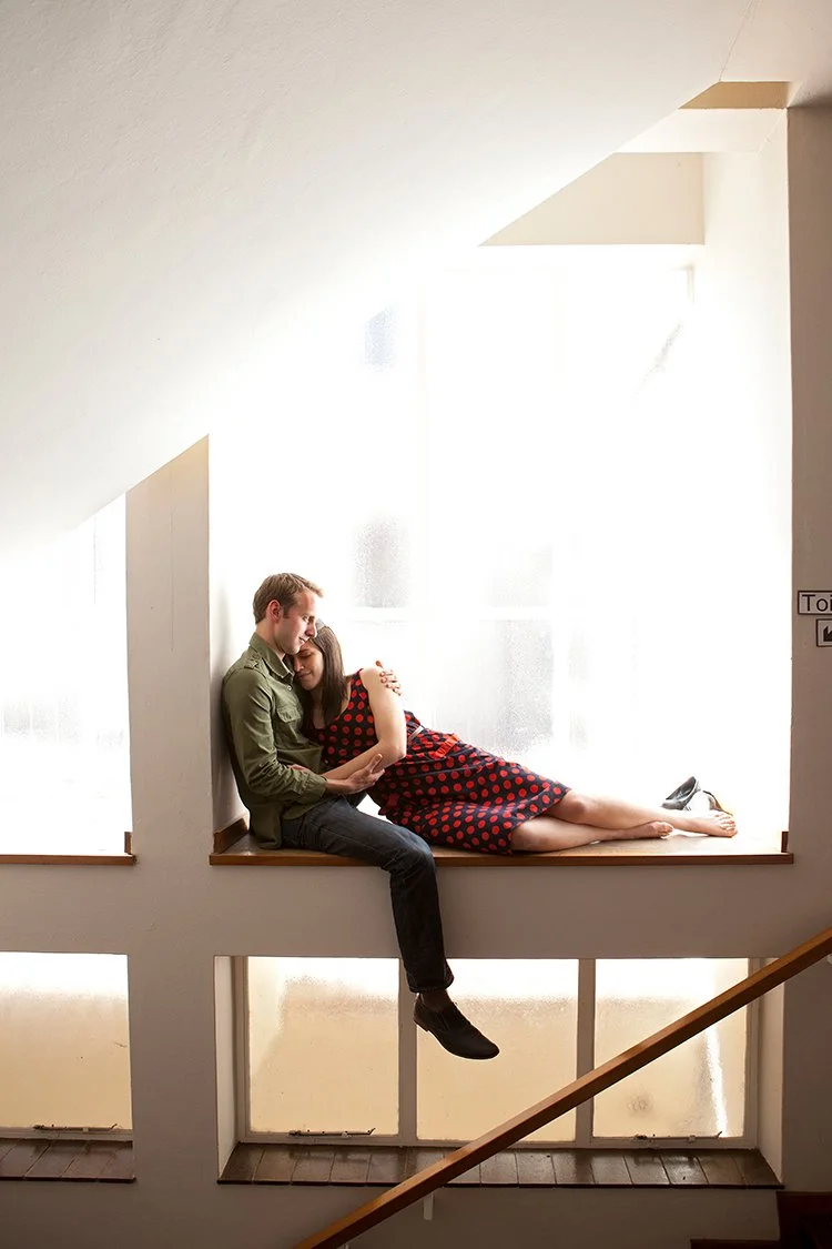 couple lying in window during couple shoot