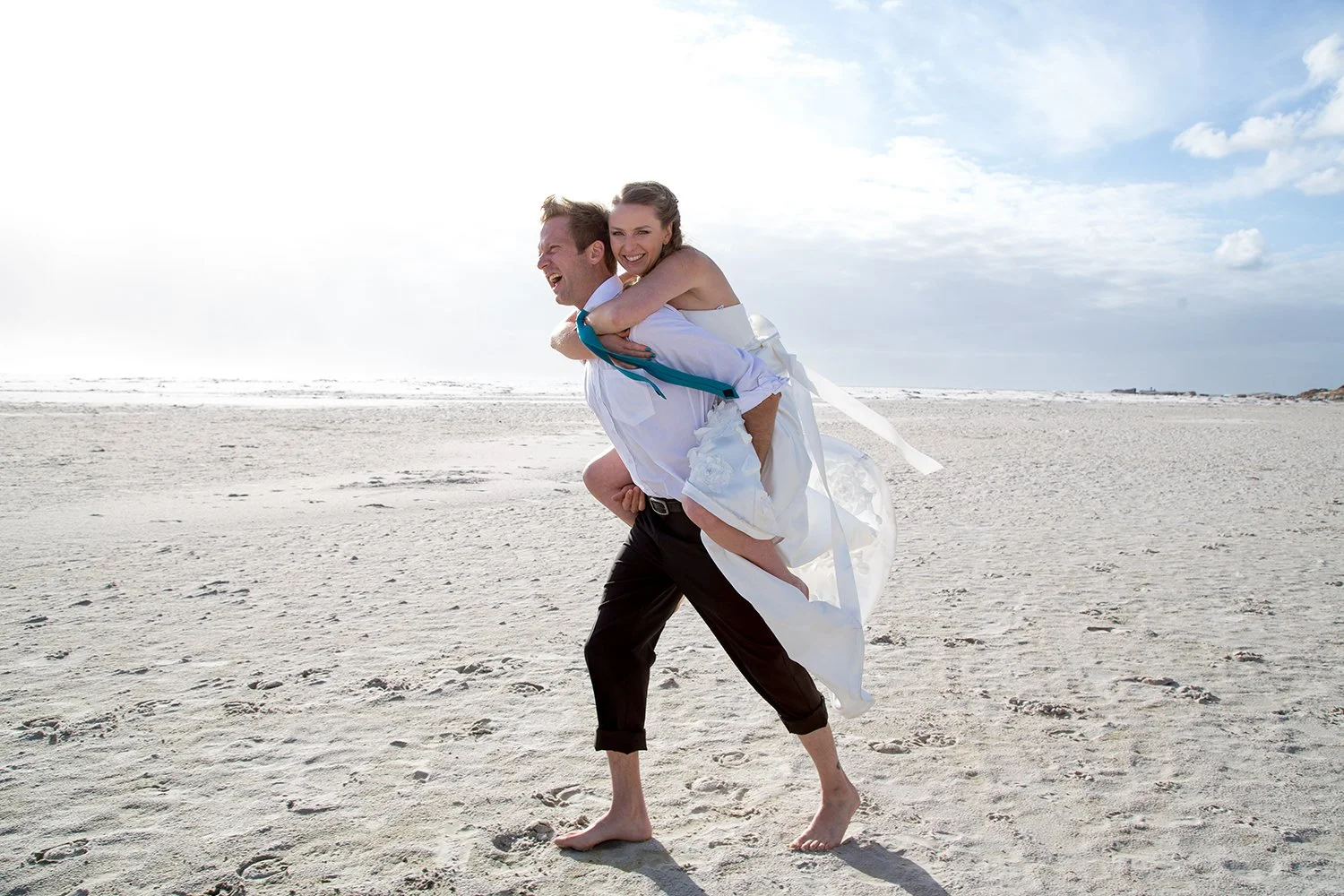 groom giving bride a piggie back