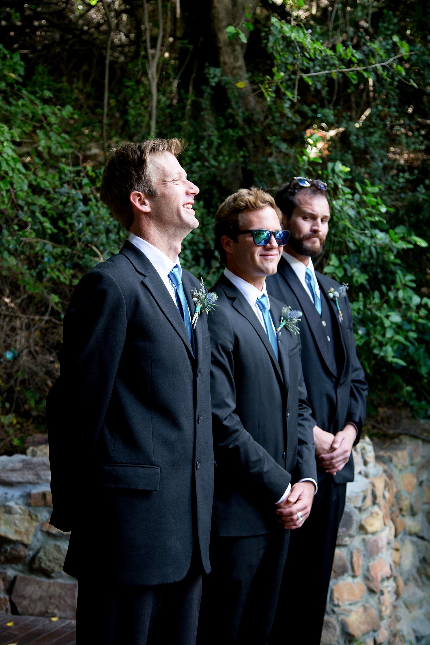 groom standing next to his best men during wedding ceremony