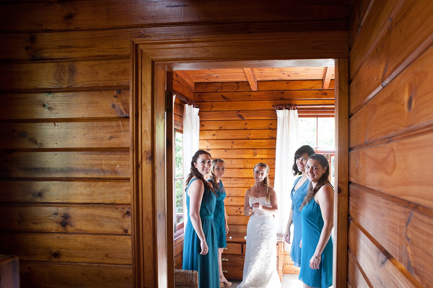 bridesmaids and bride standing in doorway