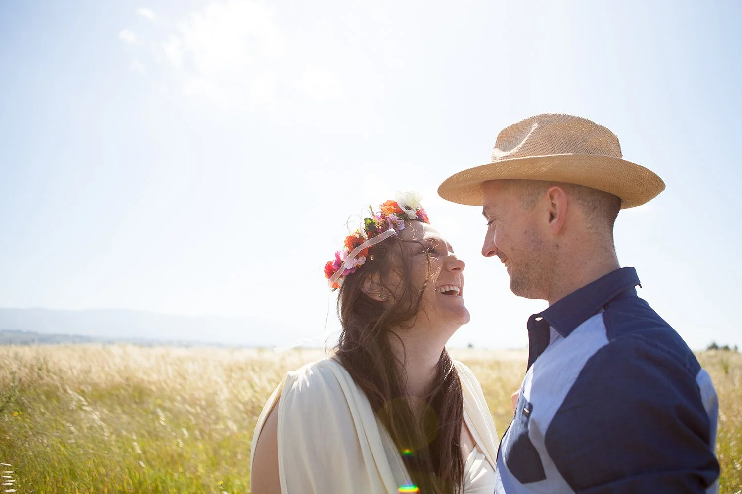 couple laughing in field during couple shoot
