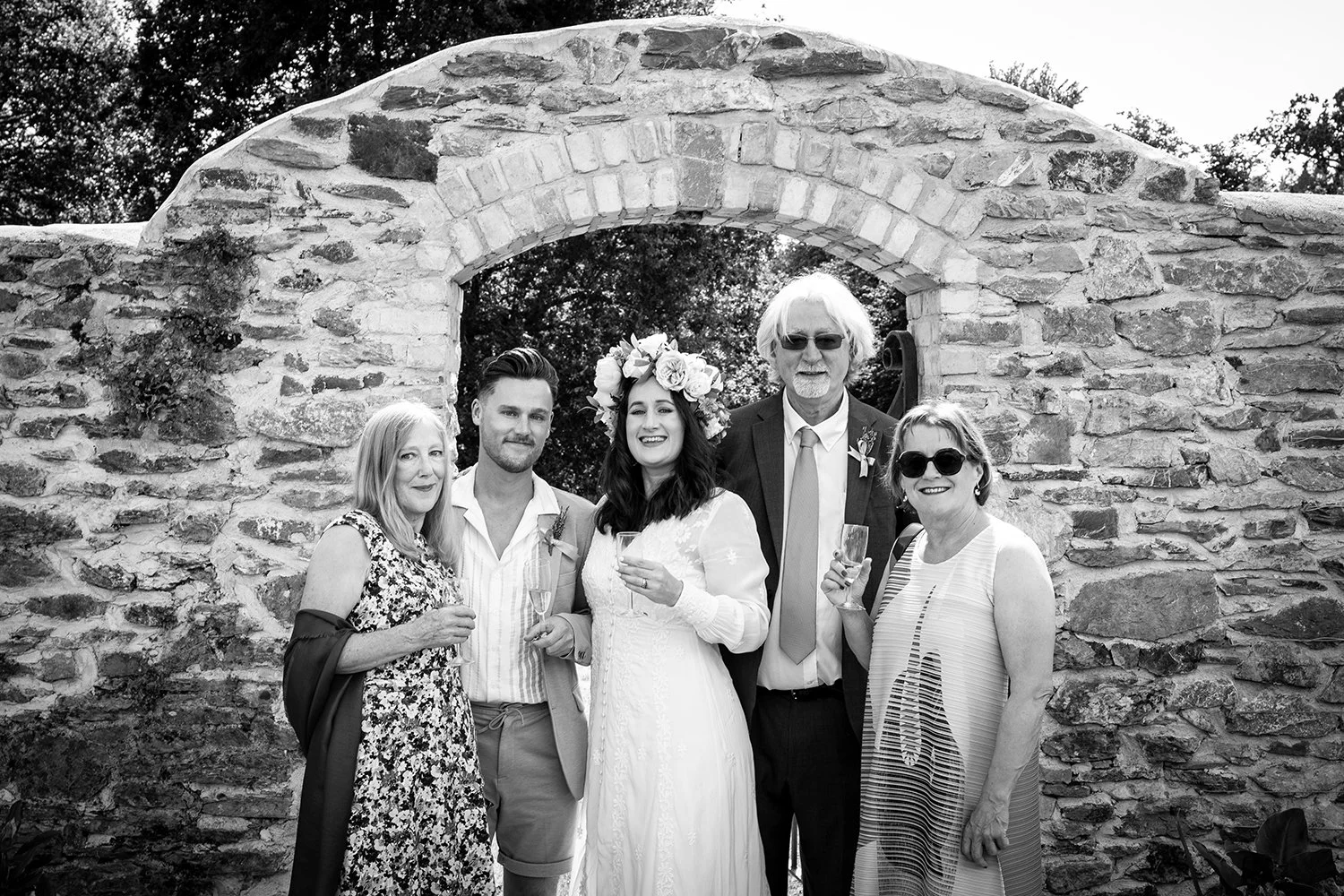 portrait of bride and family in front of wall