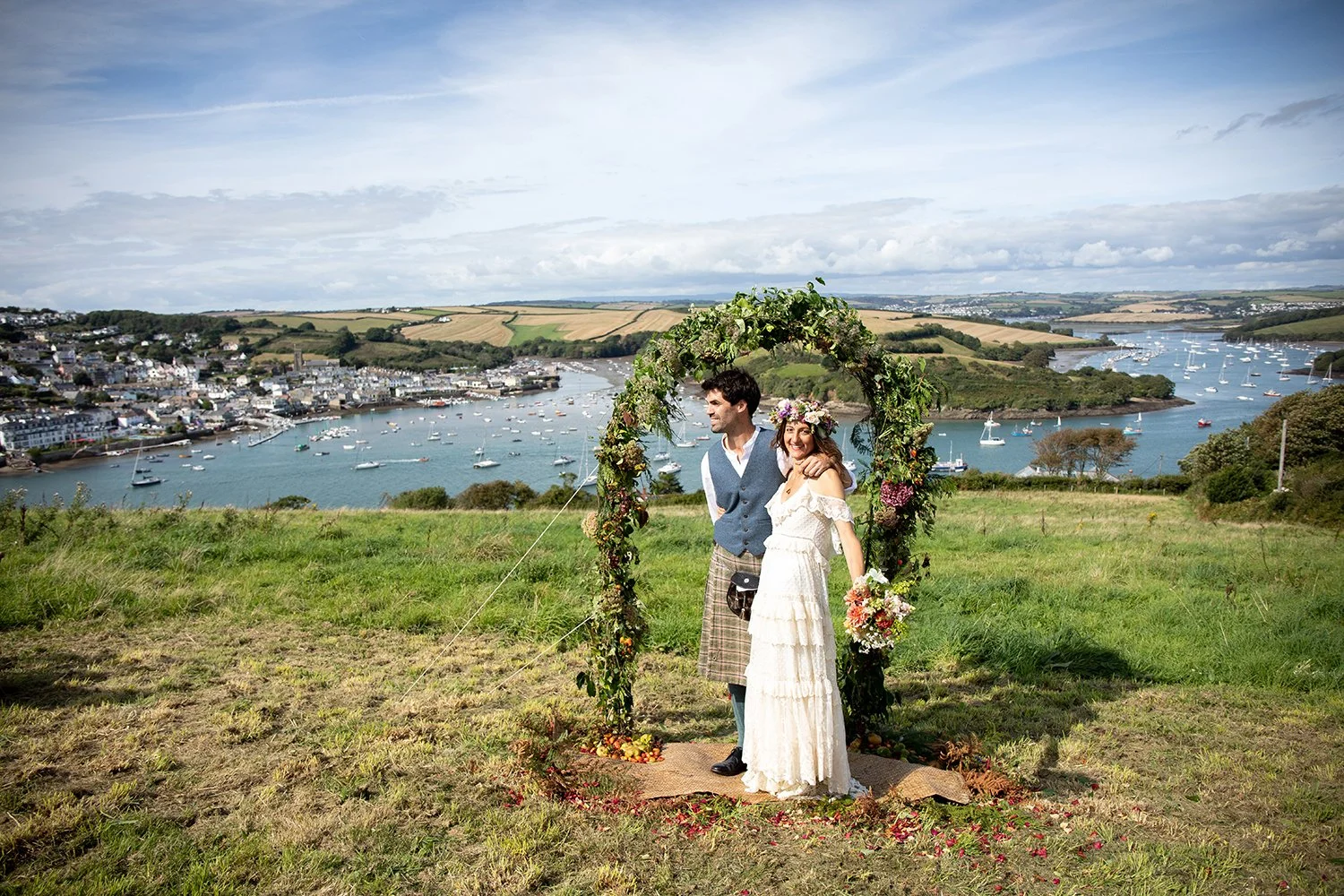 bride and groom getting married in devon field