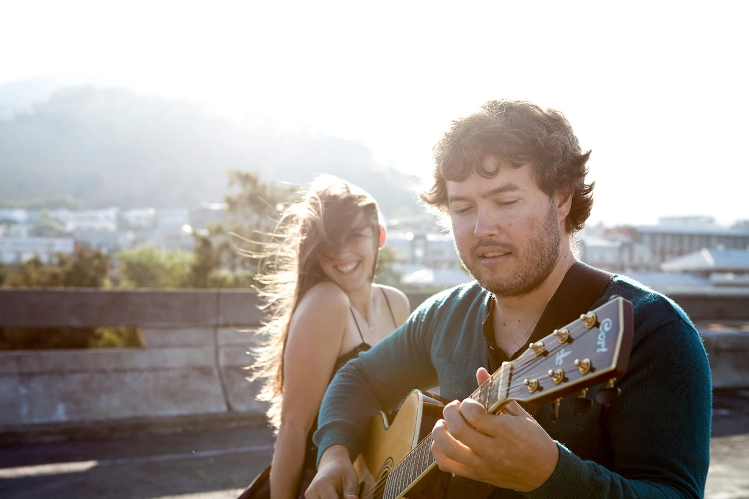 musician playing music to girlfriend during couple shoot