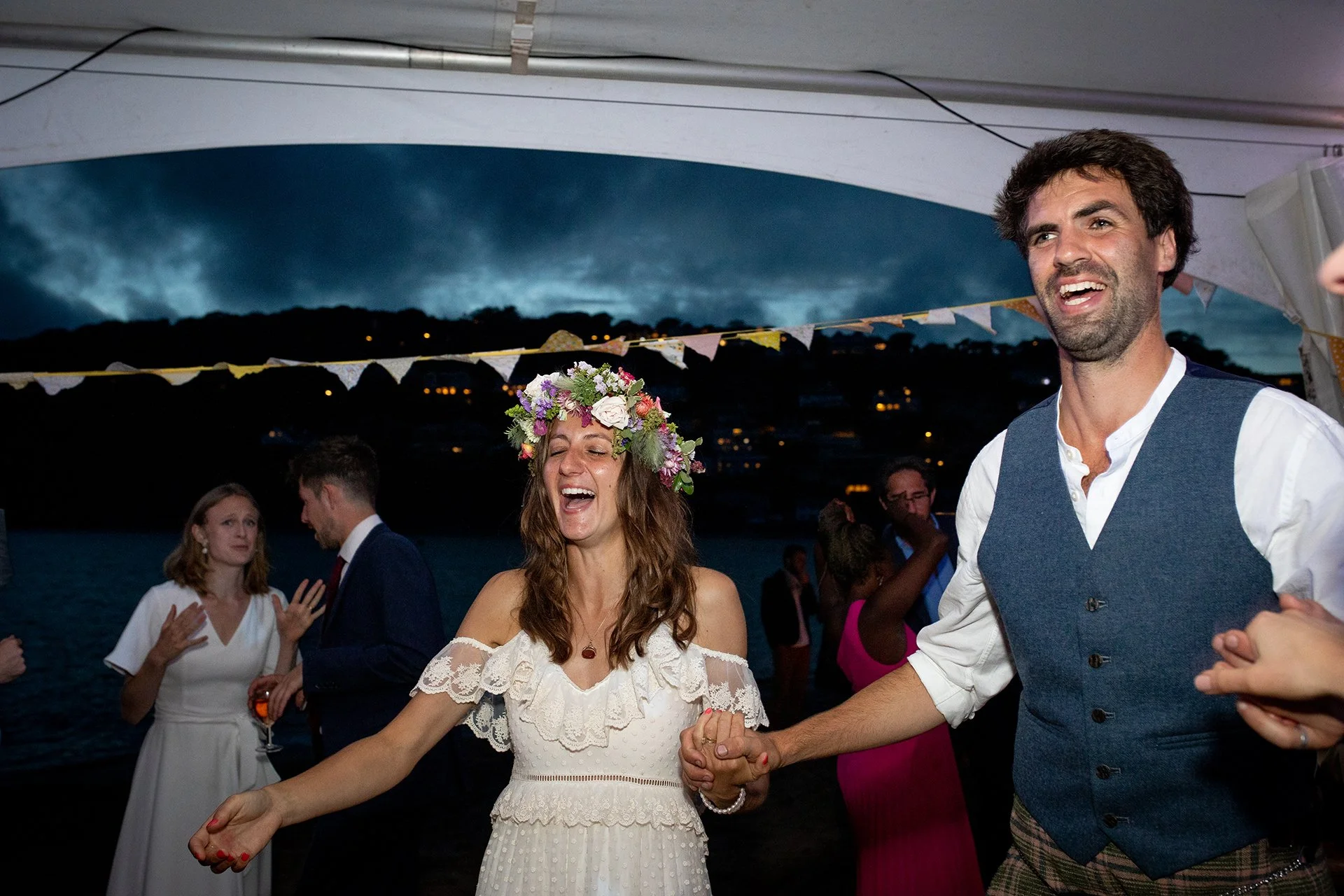 bride and groom on dance floor laughing