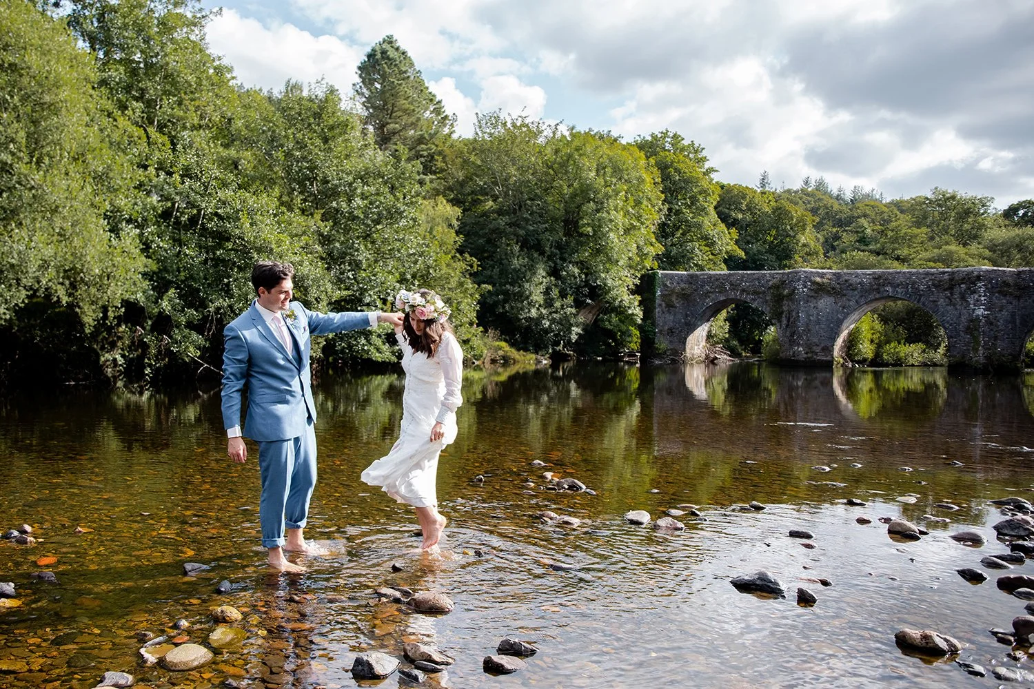 bride and groom dancing in river in staverton devon