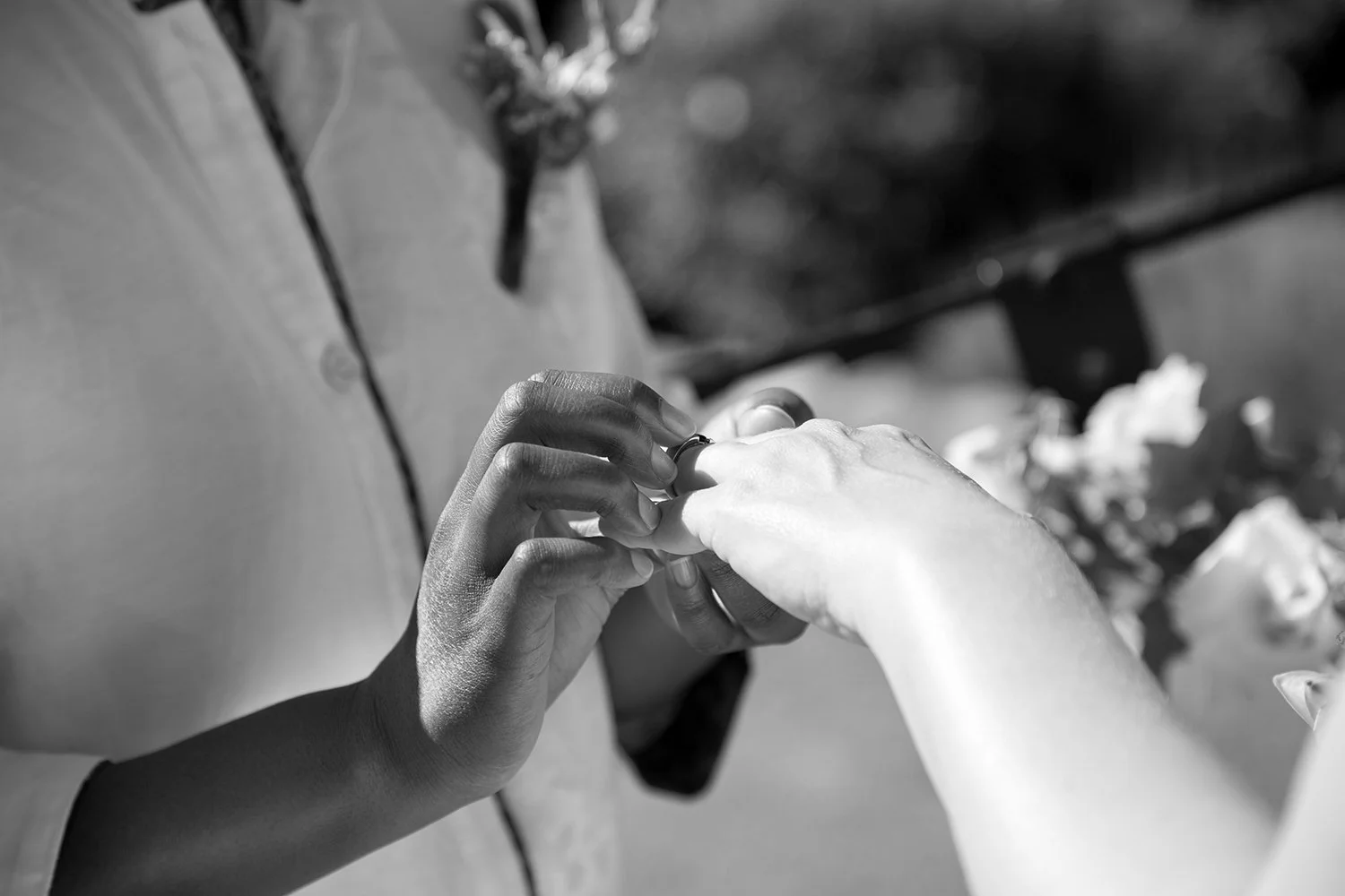 detail of hand putting on wedding ring