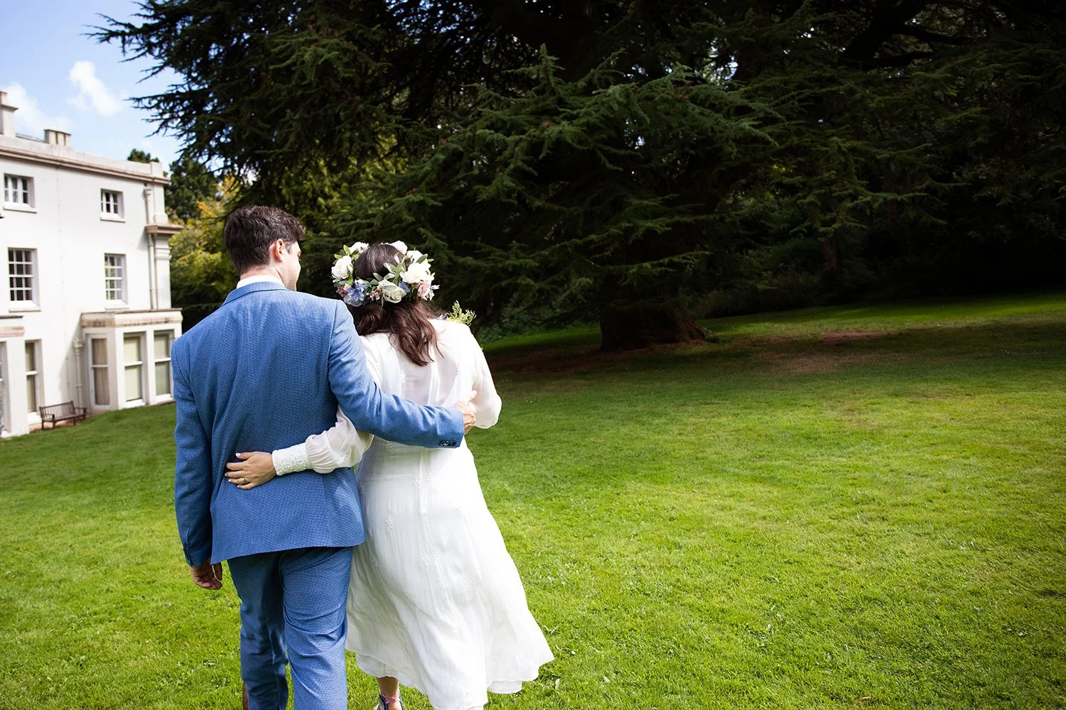 bride and groom walking arm in arm