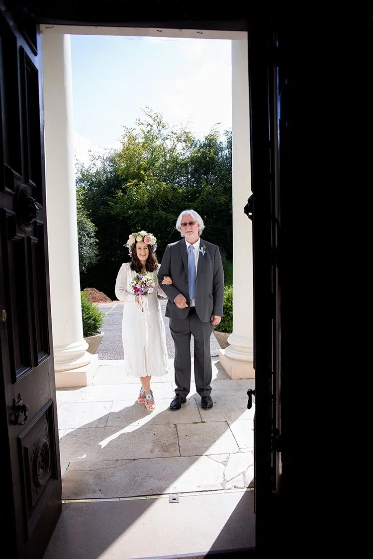 bride with her dad standing in doorway