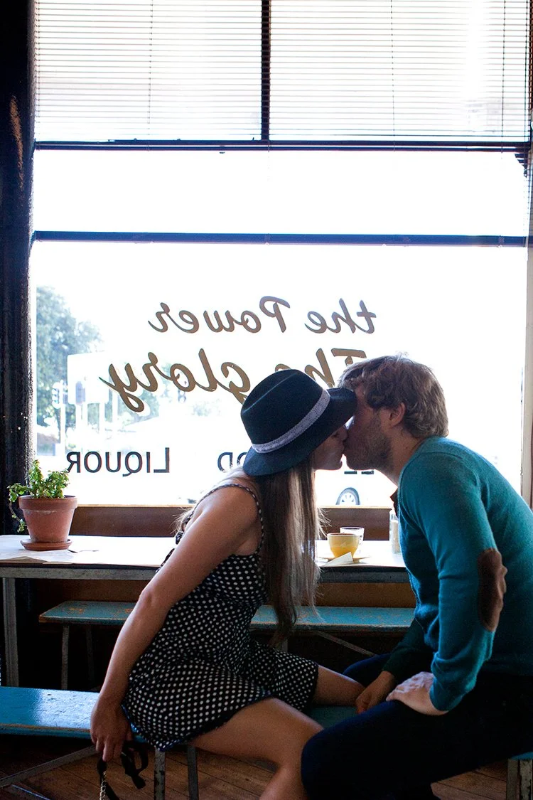 couple kissing in cafe