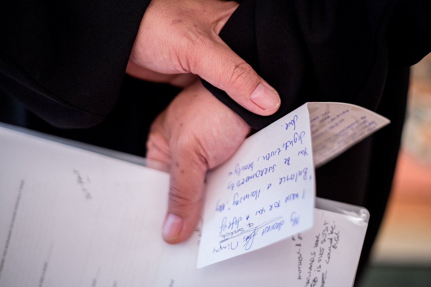 deatil of hands holding a speech at Indian wedding