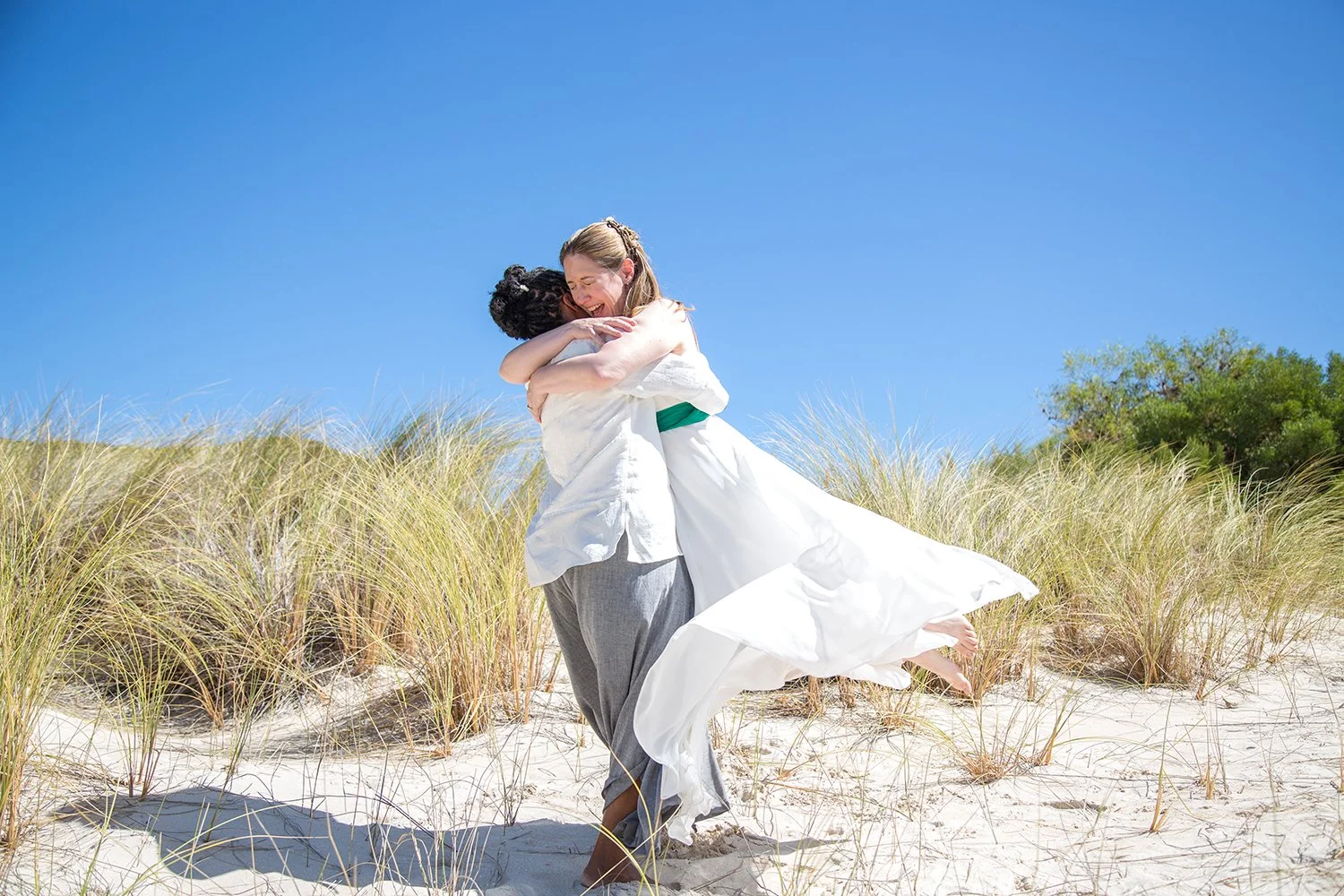same sex wedding couple hugging each other
