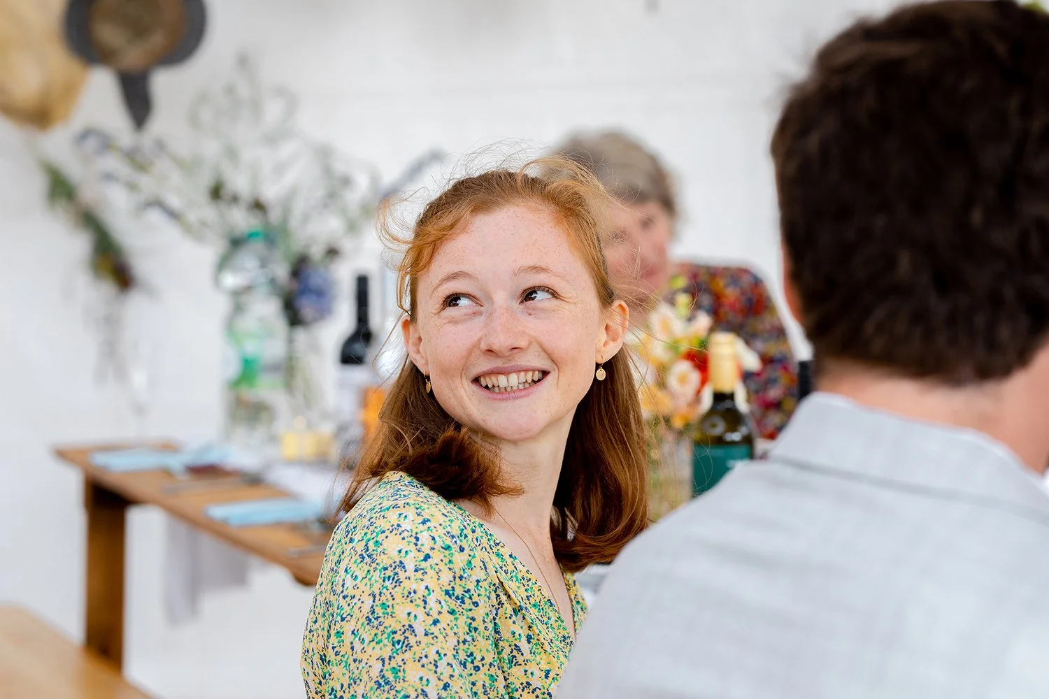 wedding guest looking over her shoulder smiling