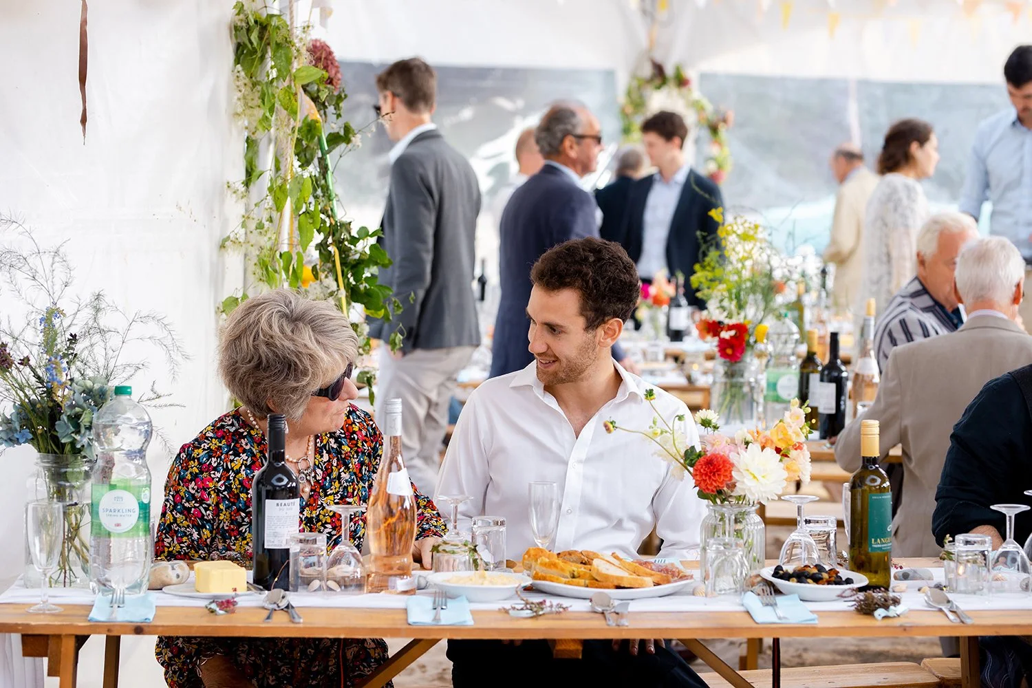 wedding guests talking at beach wedding in devon