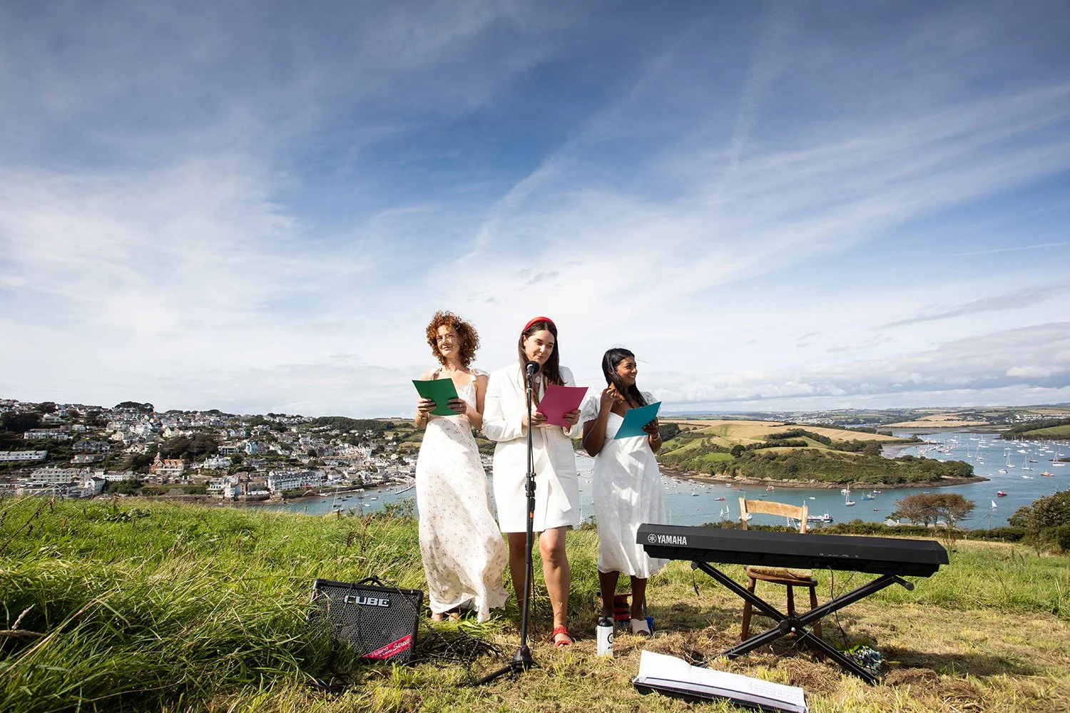 three bridesmaids singing in south devon field