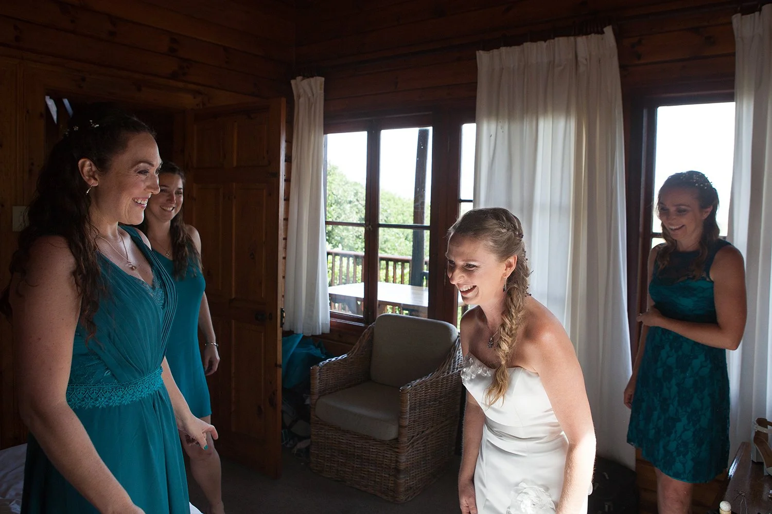 portrait of bride laughing getting ready with bridesmaids