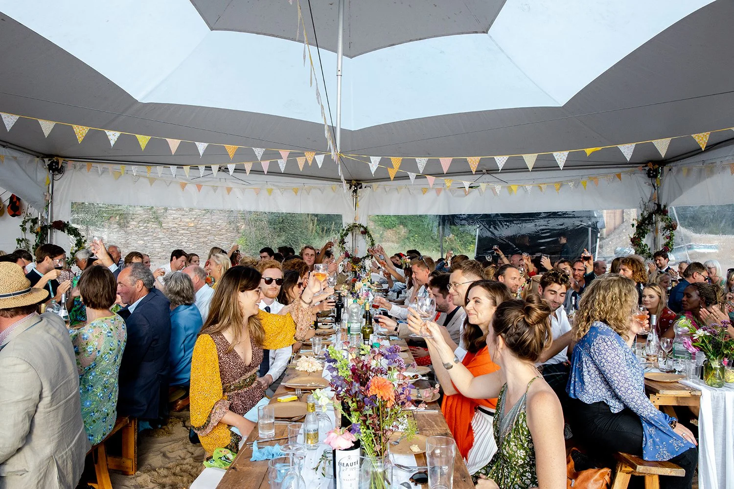 wedding party toasting by raising their glasses