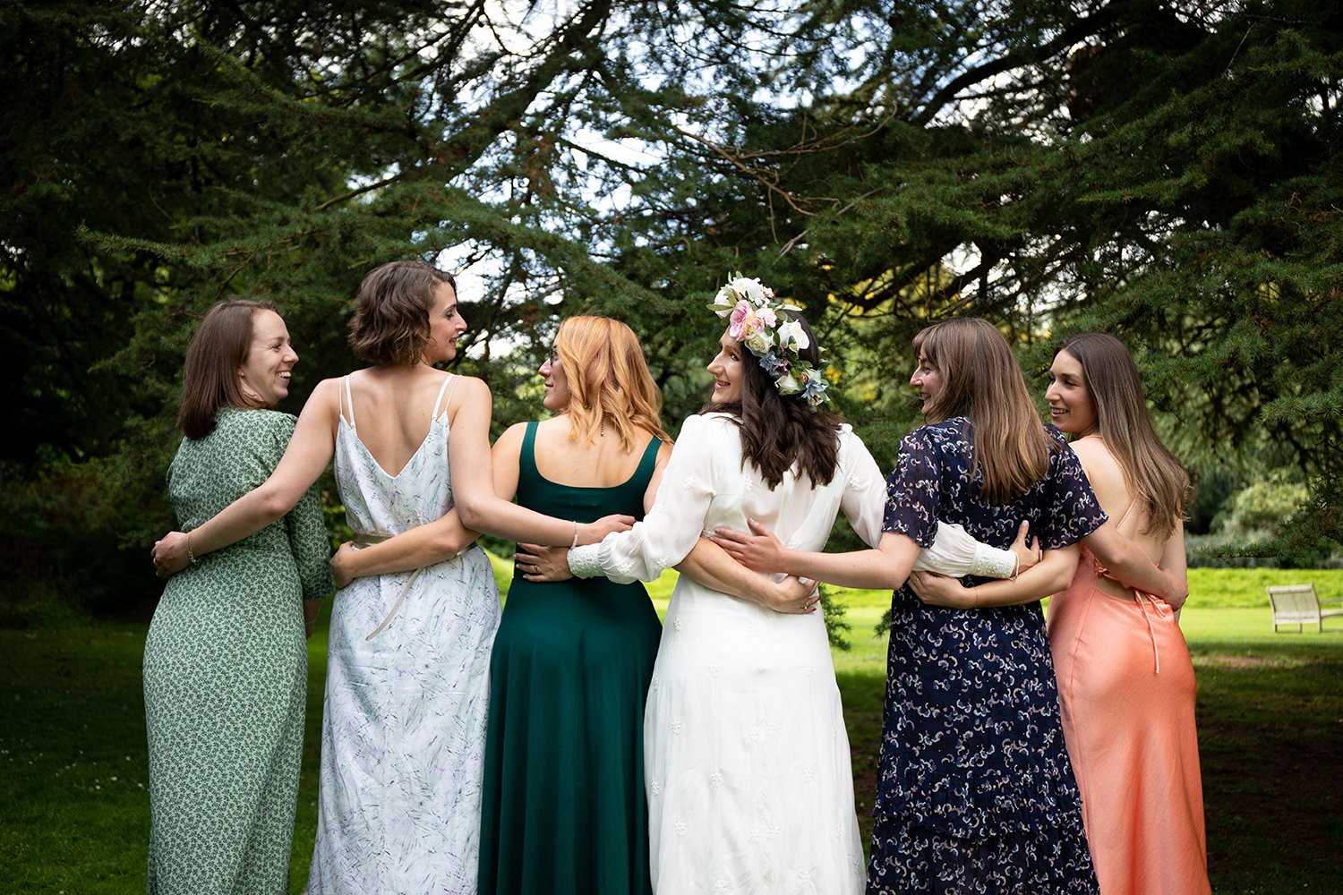 bride arm in arm with her bridesmaids