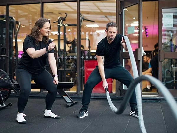 Learners performing a battle rope exercise during Level 3 PT practical training.