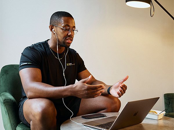Personal trainer studying business course materials on laptop