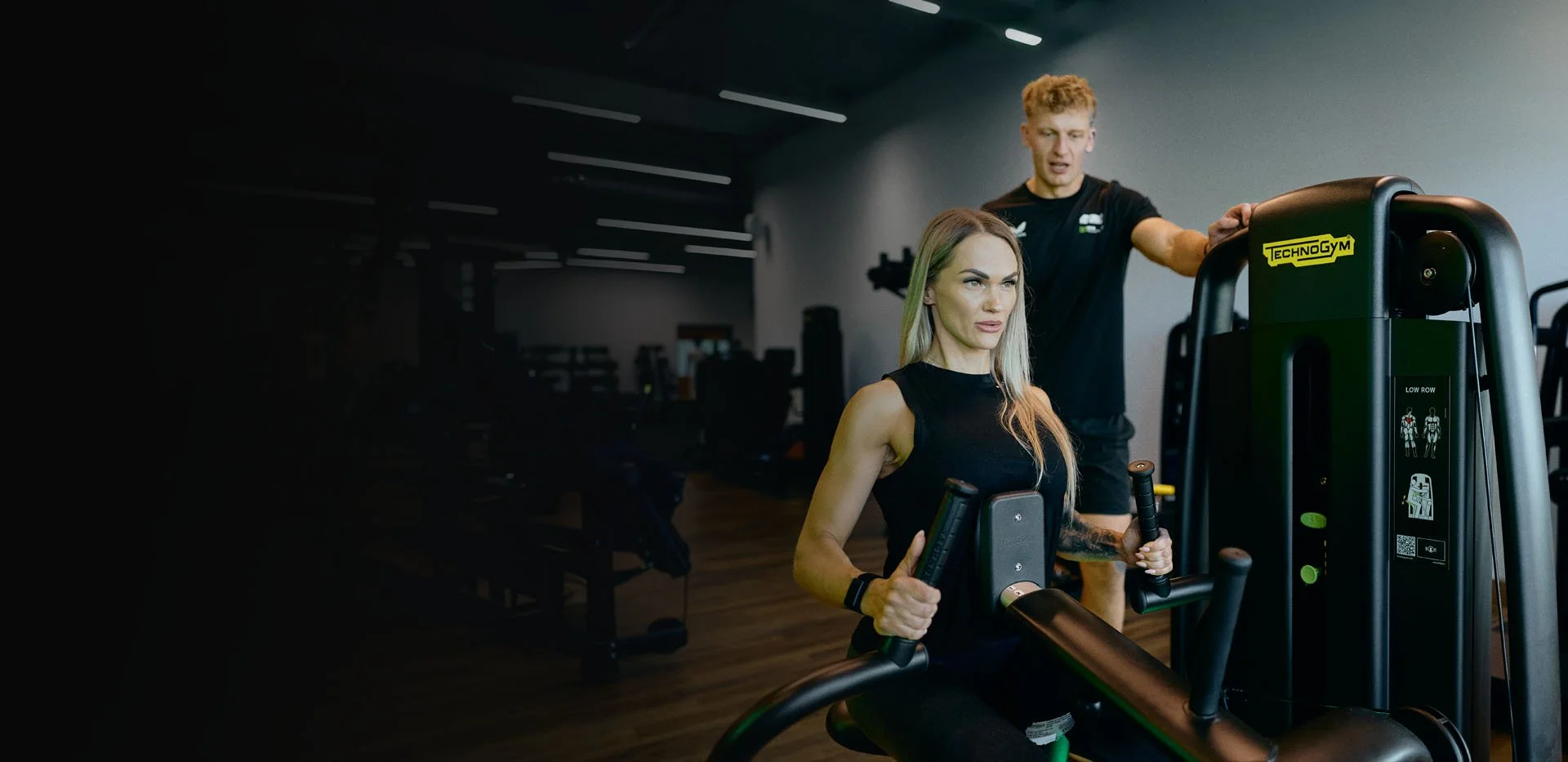 Personal trainer coaching client in gym
