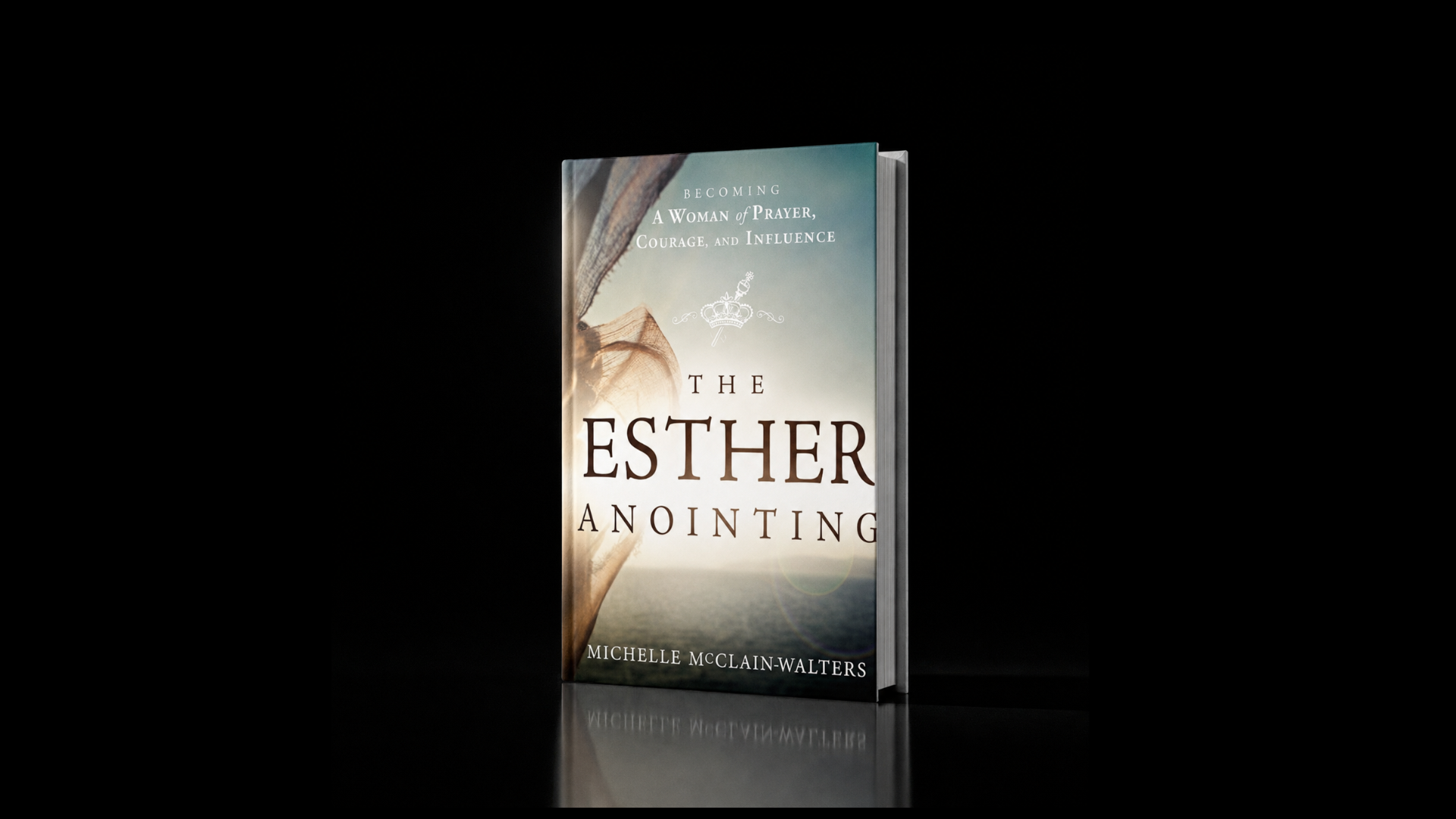A hardcover book titled "The Esther Anointing" by Michelle McClain-Walters, standing upright against a black background with a soft light illuminating it.