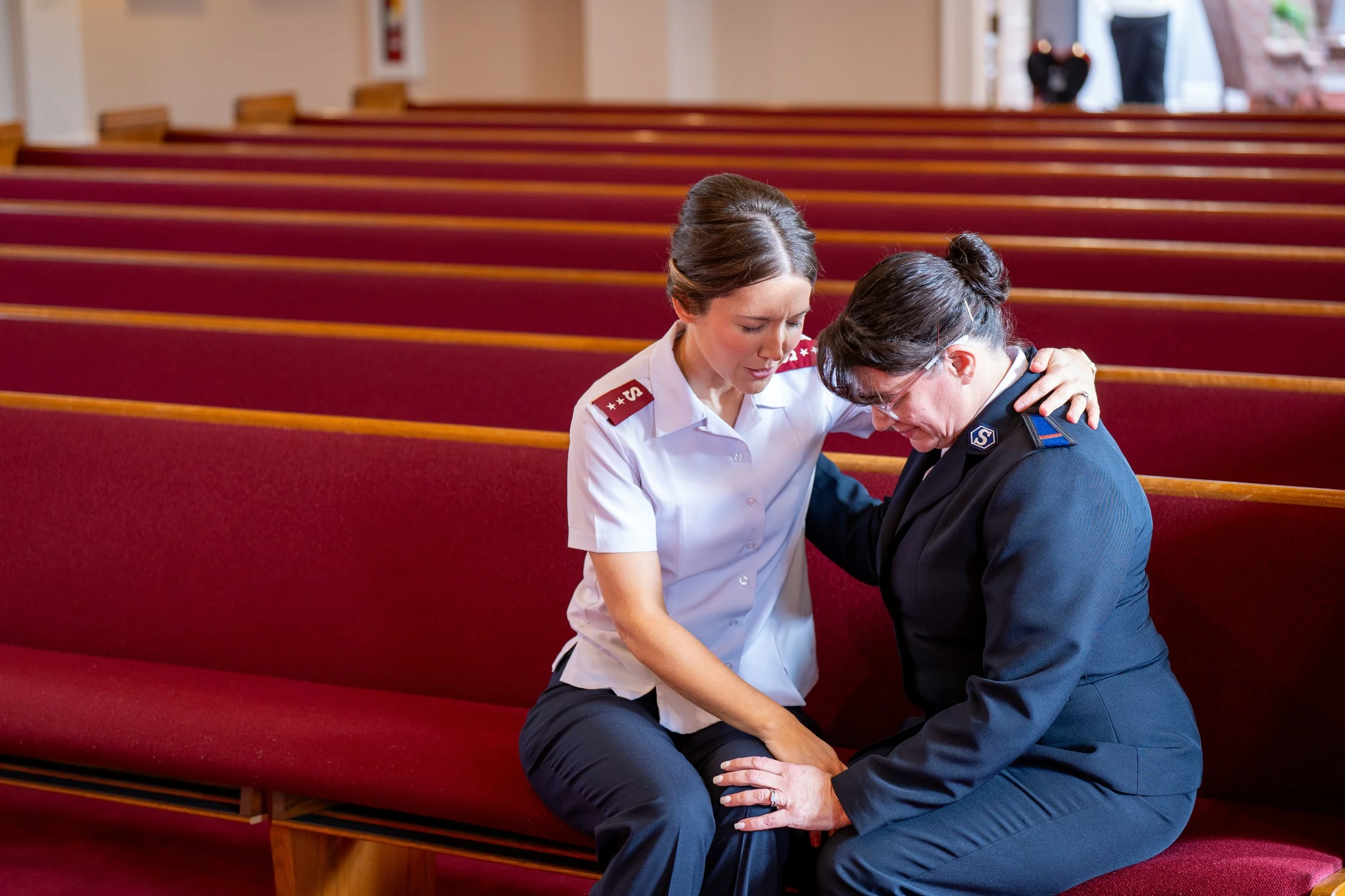 Two women praying in church