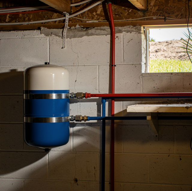 copper water pipe with pressure gauge near well tank