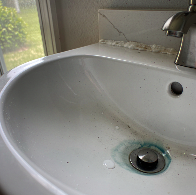A white bathroom sink with a bar of soap on the counter and a pencil holder nearby.