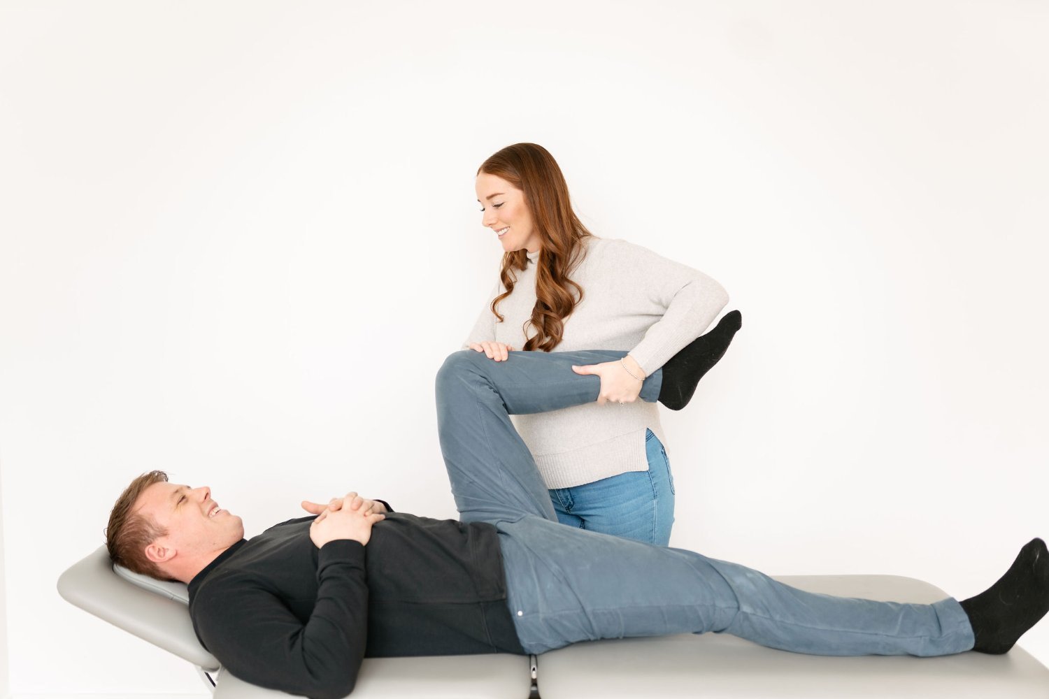 Physiotherapist performing a hamstring leg stretch on a patient at The Wellness Hub in Stoney Creek, Ontario