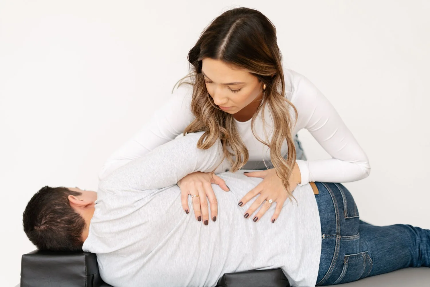 Osteopath performing spinal manipulation on a patient lying face down at The Wellness Hub in Stoney Creek, Ontario
