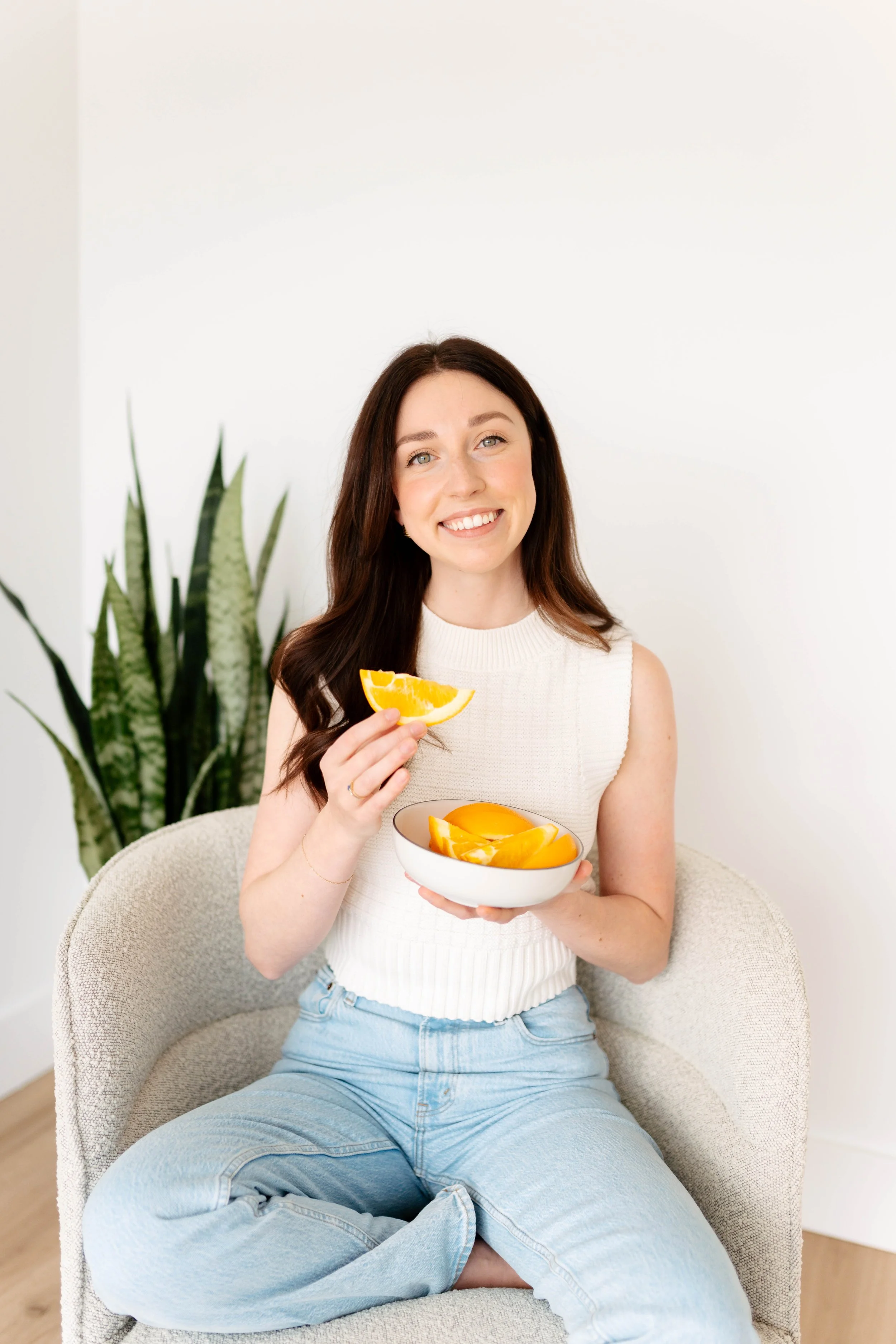 dr nora naturopath doctor in stoney creek holding oranges