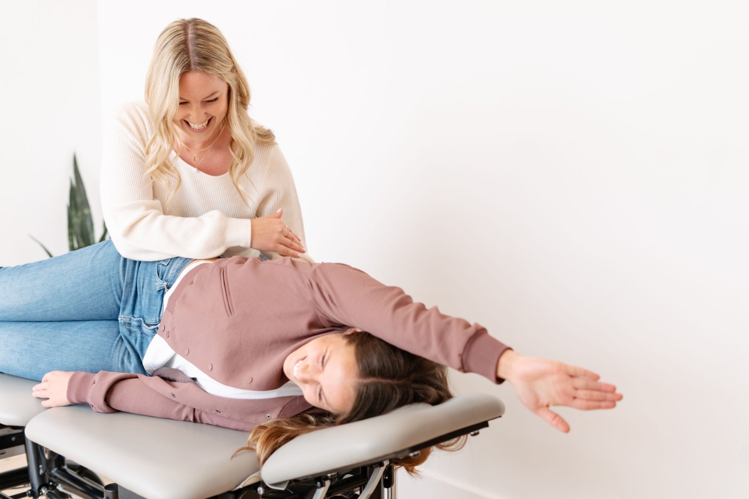 Pregnant woman receiving a prenatal chiropractic adjustment on a treatment table at The Wellness Hub in Stoney Creek, Ontario