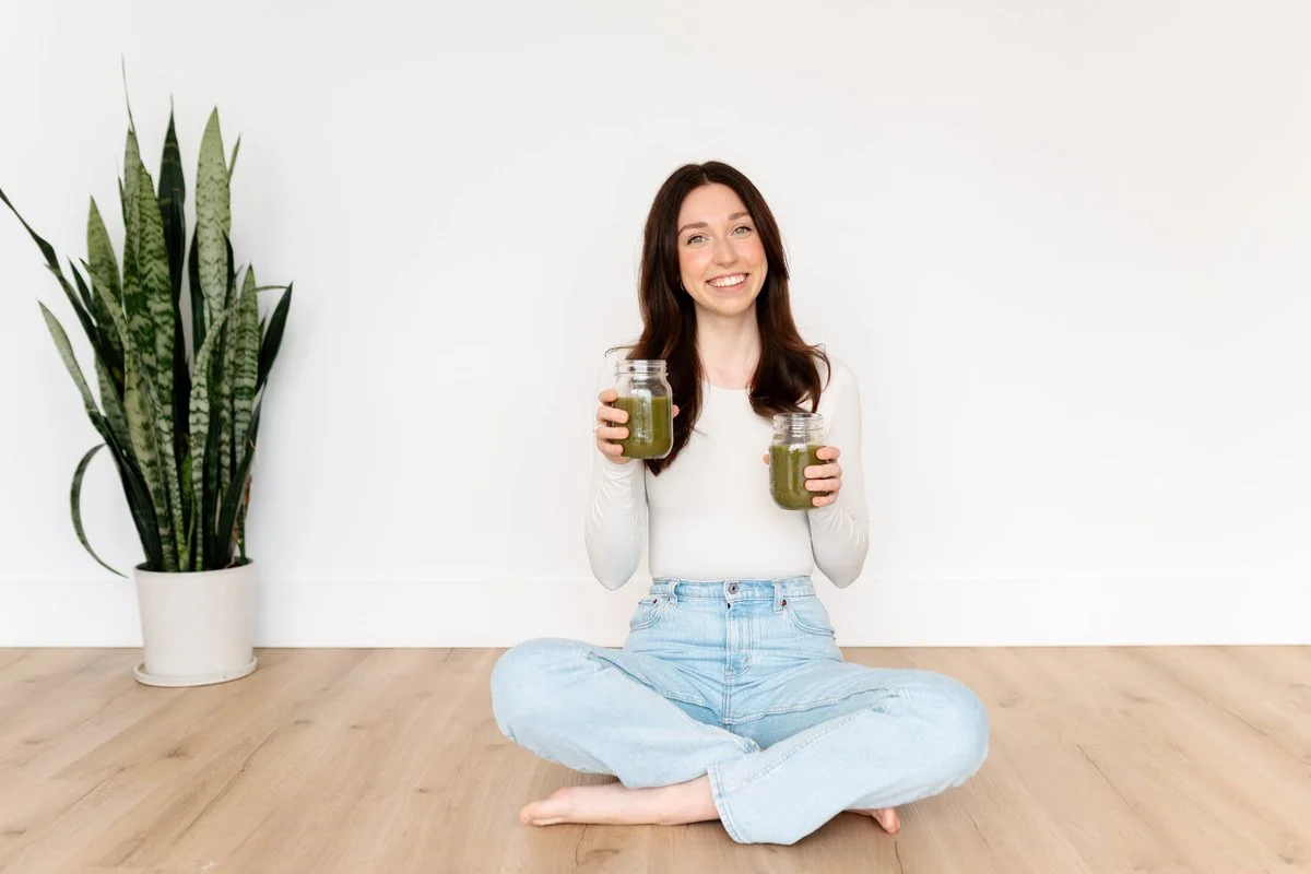 Naturopathy patient holding green smoothies during wellness nutrition session at The Wellness Hub in Stoney Creek