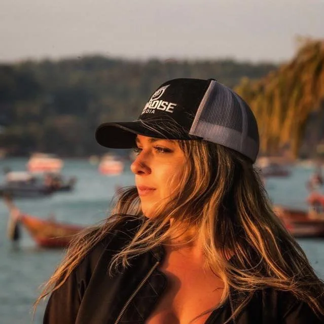 Ashley of Navadise Media looking off into the sunset during a golden hour shoot in Thailand