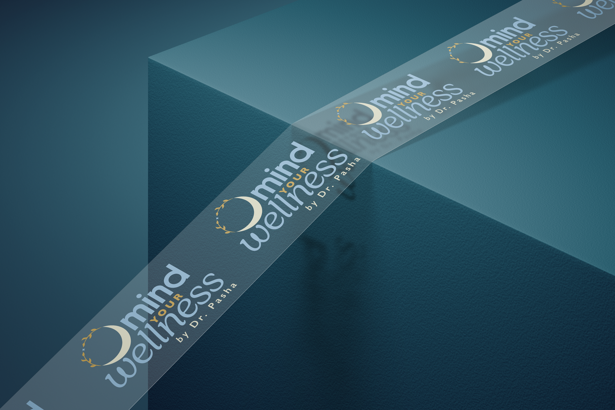 A teal-colored surface with a clear, curved plastic strip displaying the logo and text of 'Omind Your Wellness by Dr. Pasha' repeatedly.