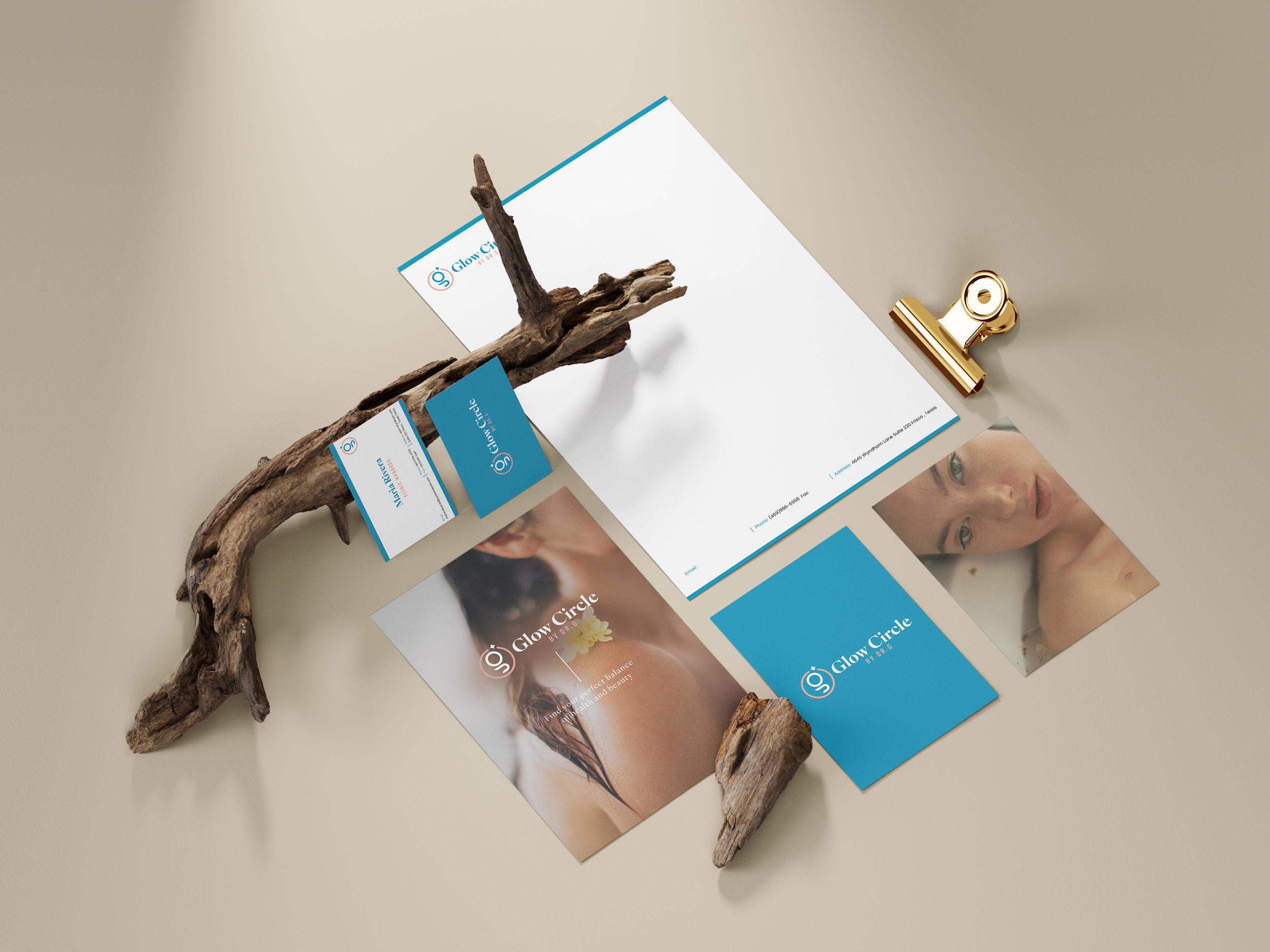 Collection of promotional materials for Glow Circle, including business cards, brochures, a photograph of a woman's face, and a piece of driftwood, on a beige surface.