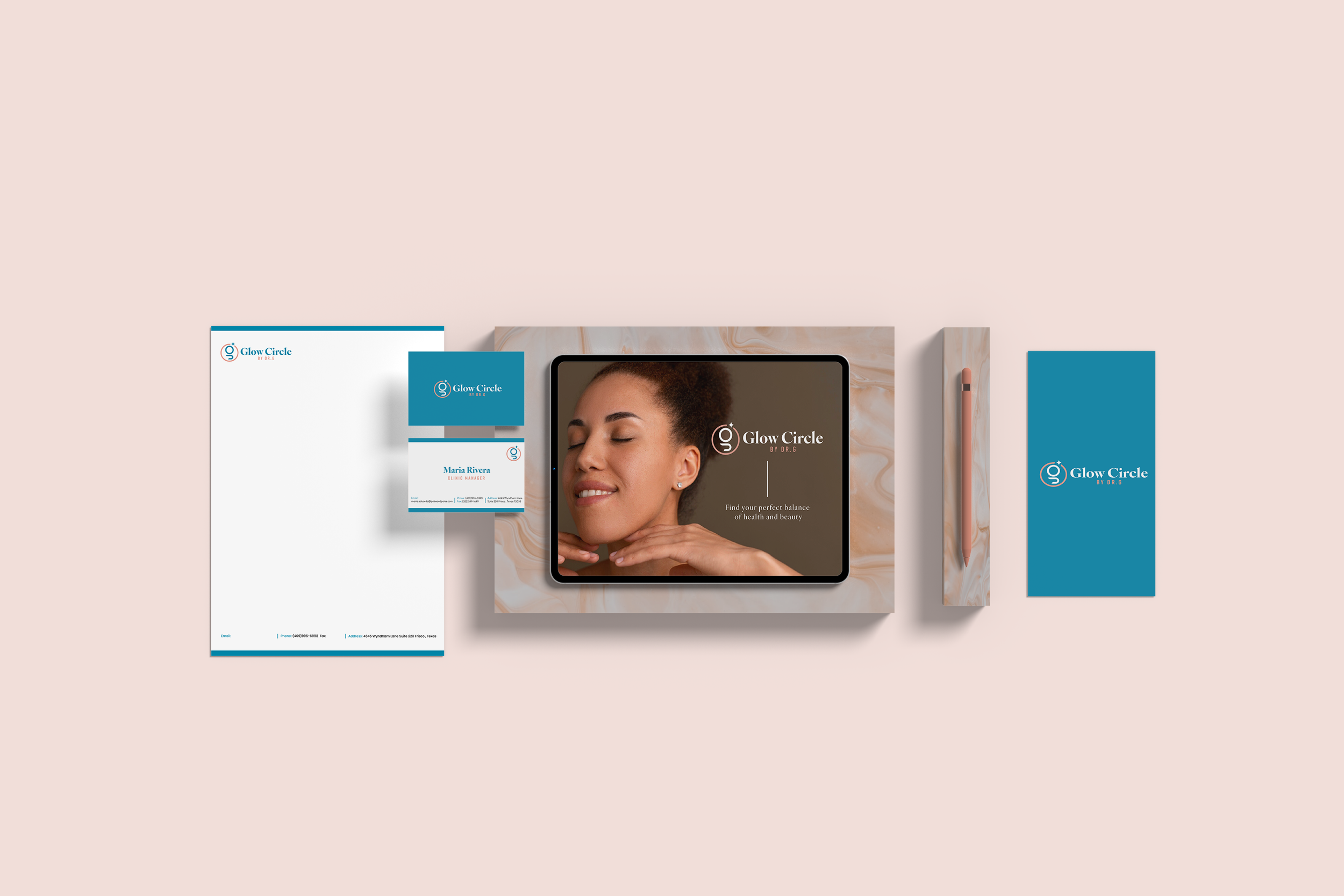 Flat lay of branding materials for Glow Circle, including a tablet with their logo, a brochure, business card, notepad, pen, and envelope, all arranged on a marble and pink background.