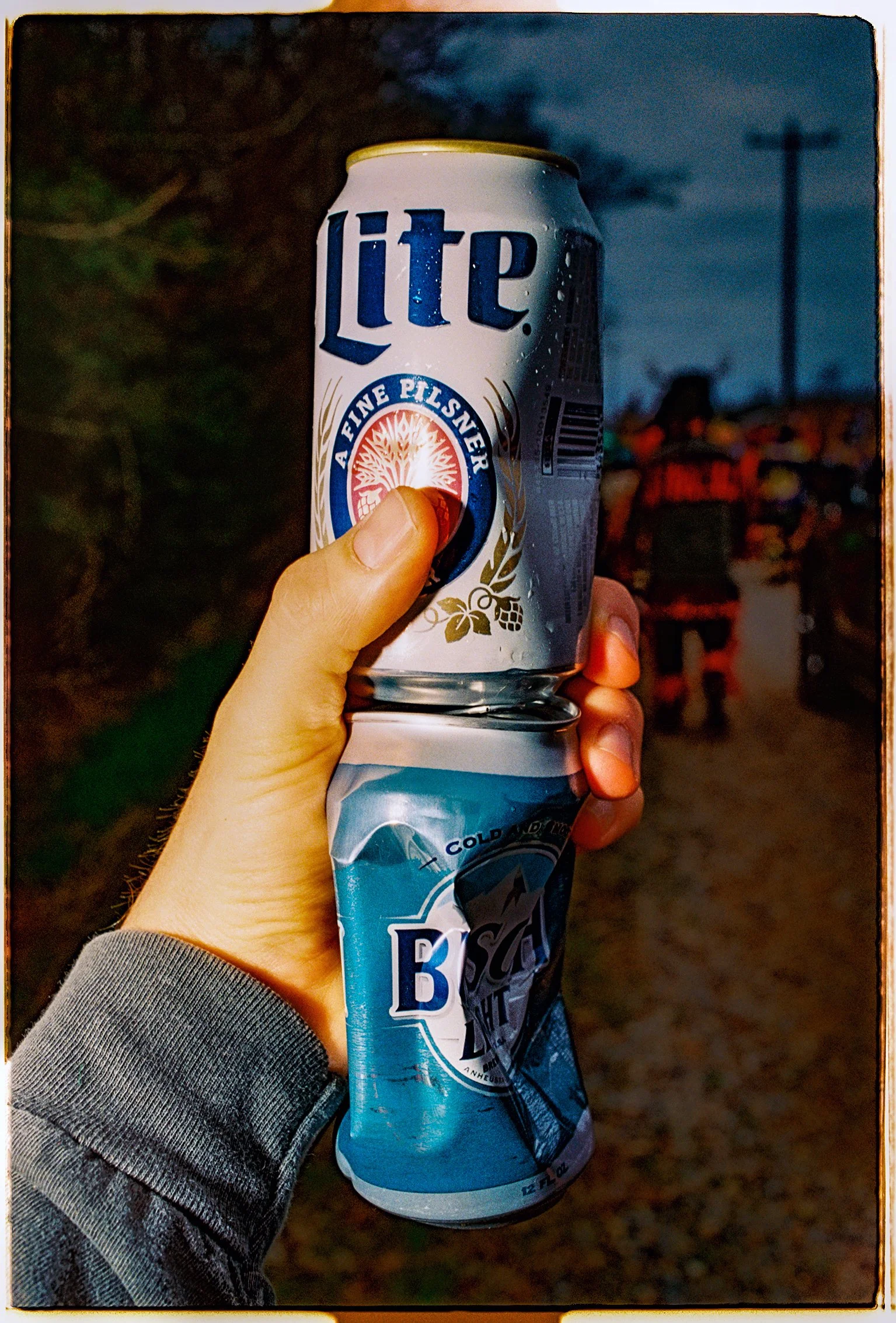 Man holding crushed beer cans