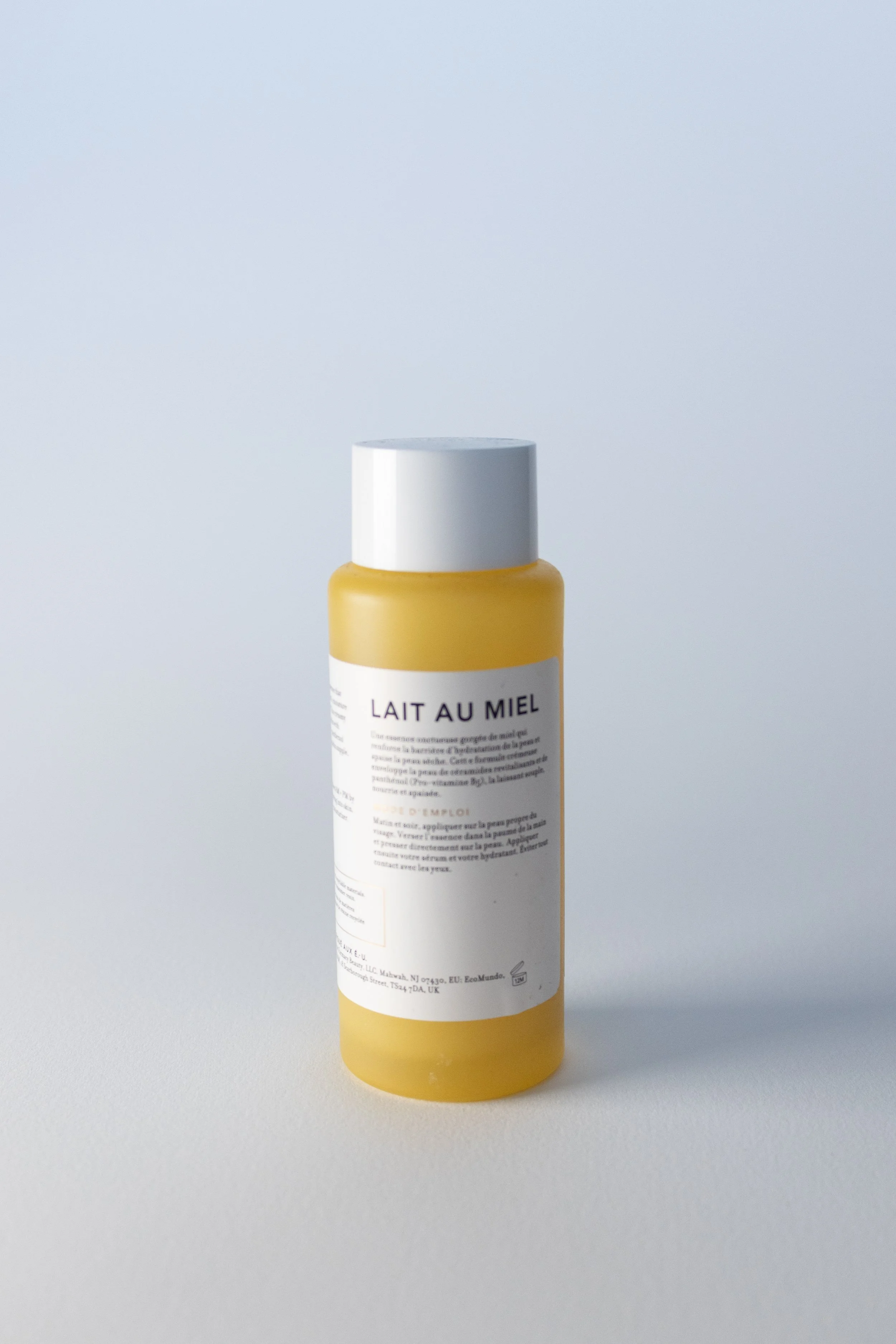 Farmacy Honey Milk Toner front. A yellow bottle with a white label and white cap back