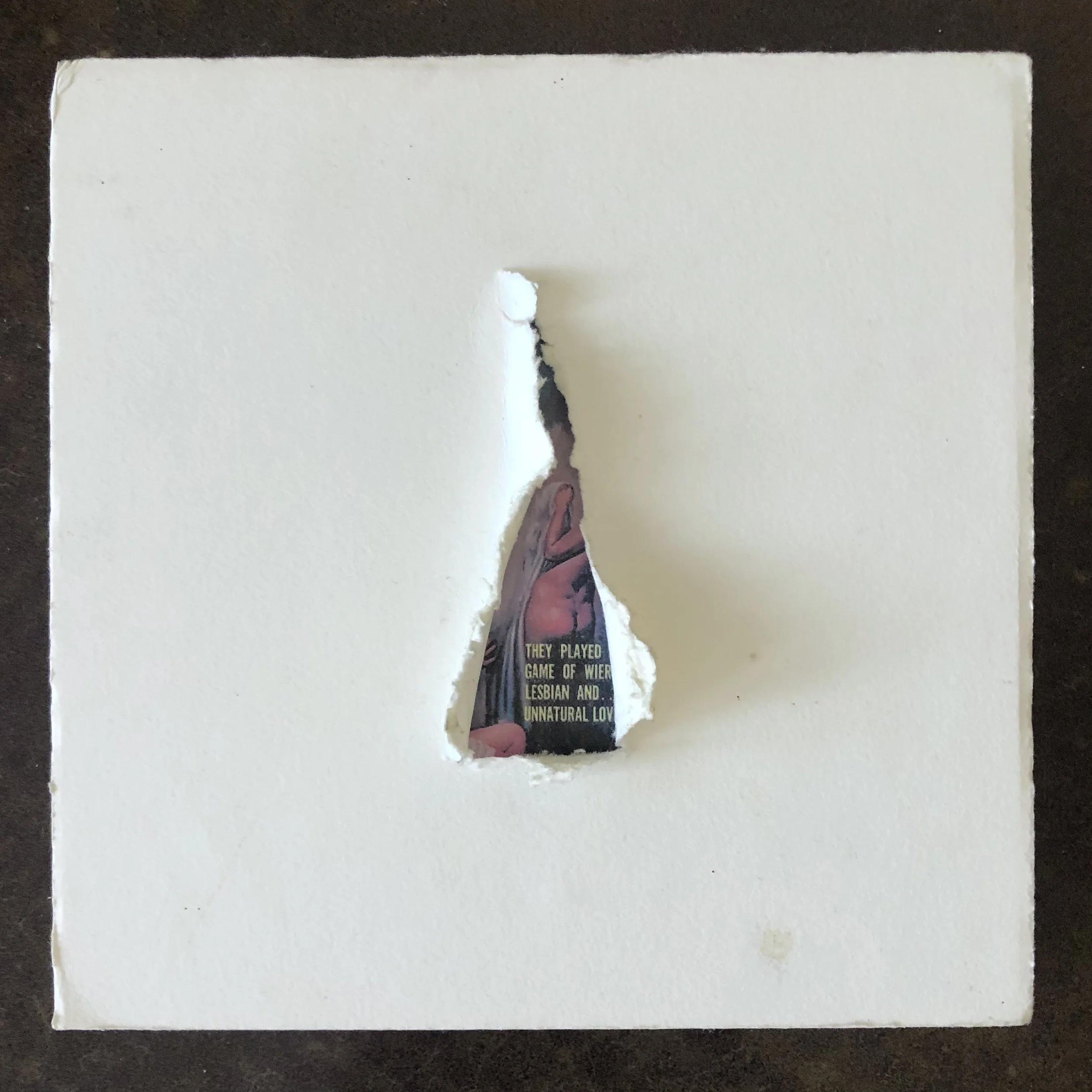 White overlay square with a hole torn open revealing a magazine cover underneath.