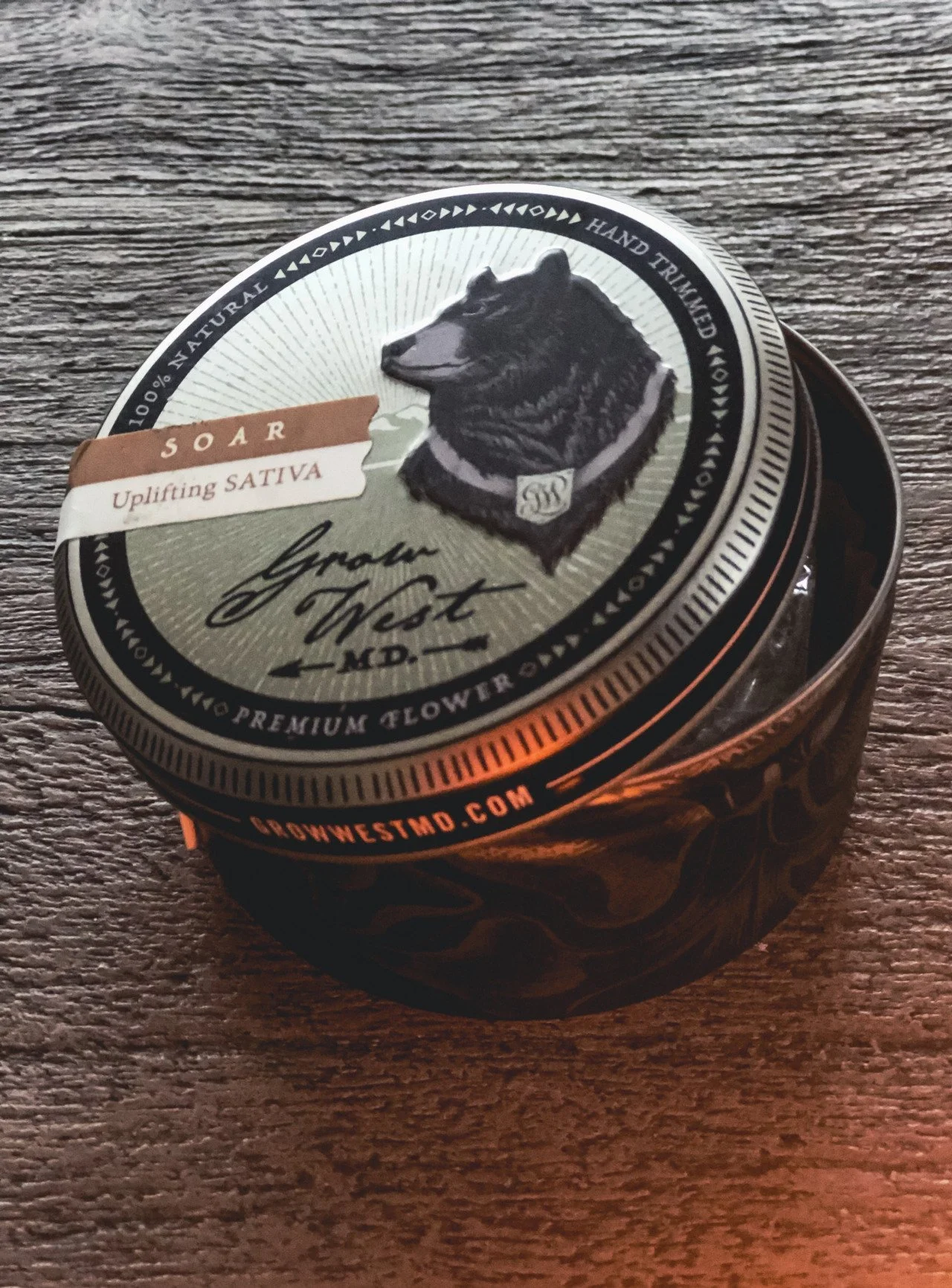 A shiny container with a picture of a bear and decorative words.
