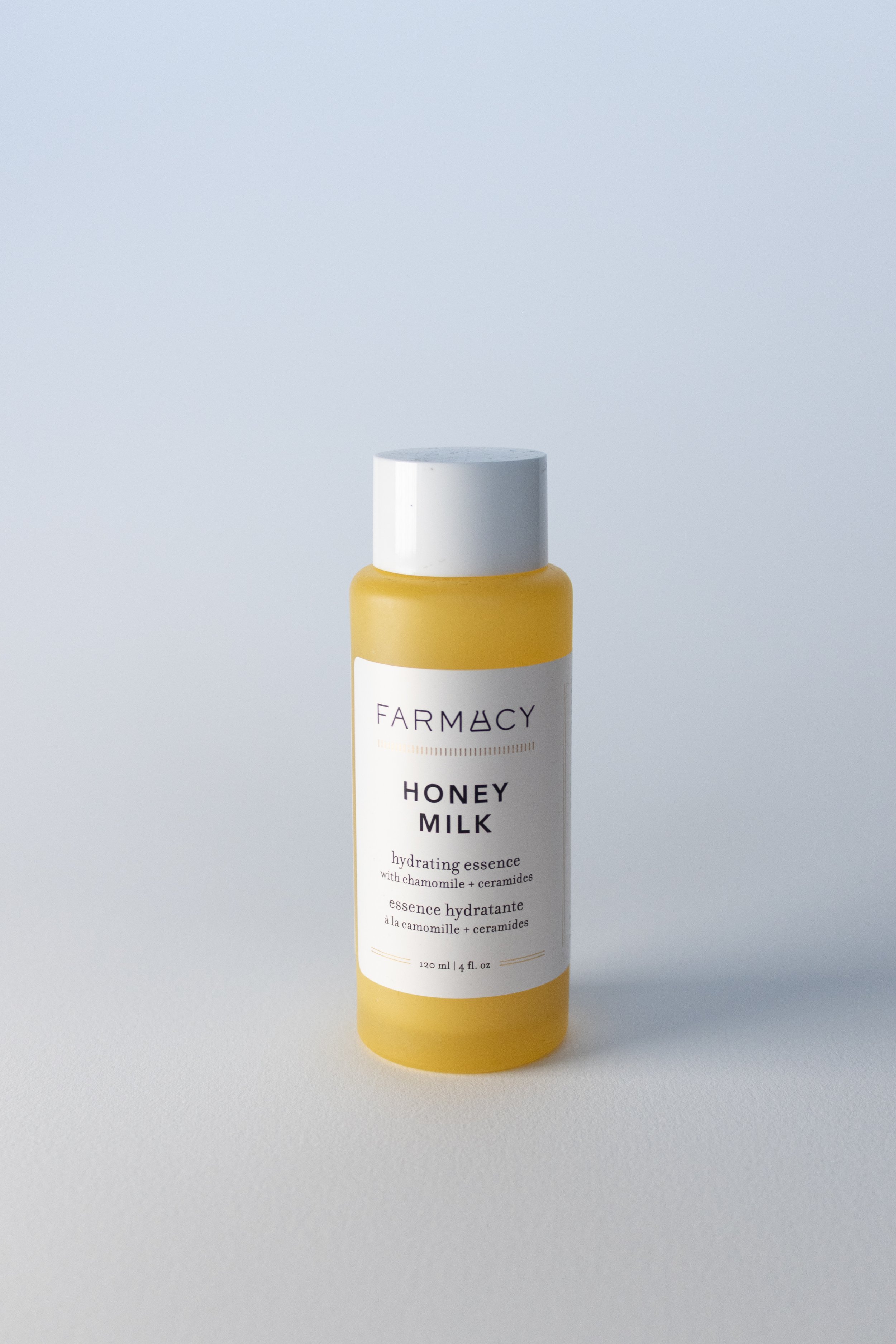 Farmacy Honey Milk Toner front. A yellow bottle with a white label and white cap