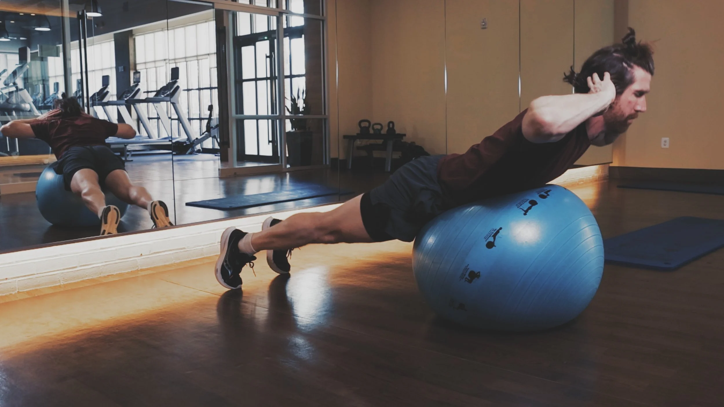 Man with beard doing sit ups on a blue Prism Fitness Smart ball