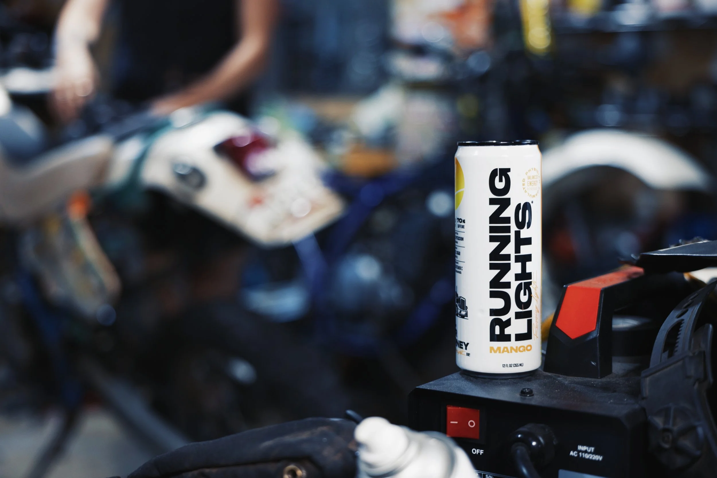 Close up of Running Lights Beverage on a welder in a motorcycle shop