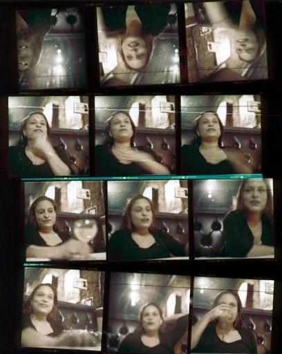 A collage of nine images showing a woman sitting in a restaurant or cafe, making different facial expressions and gestures, with a dark leather seat and brick wall background.
