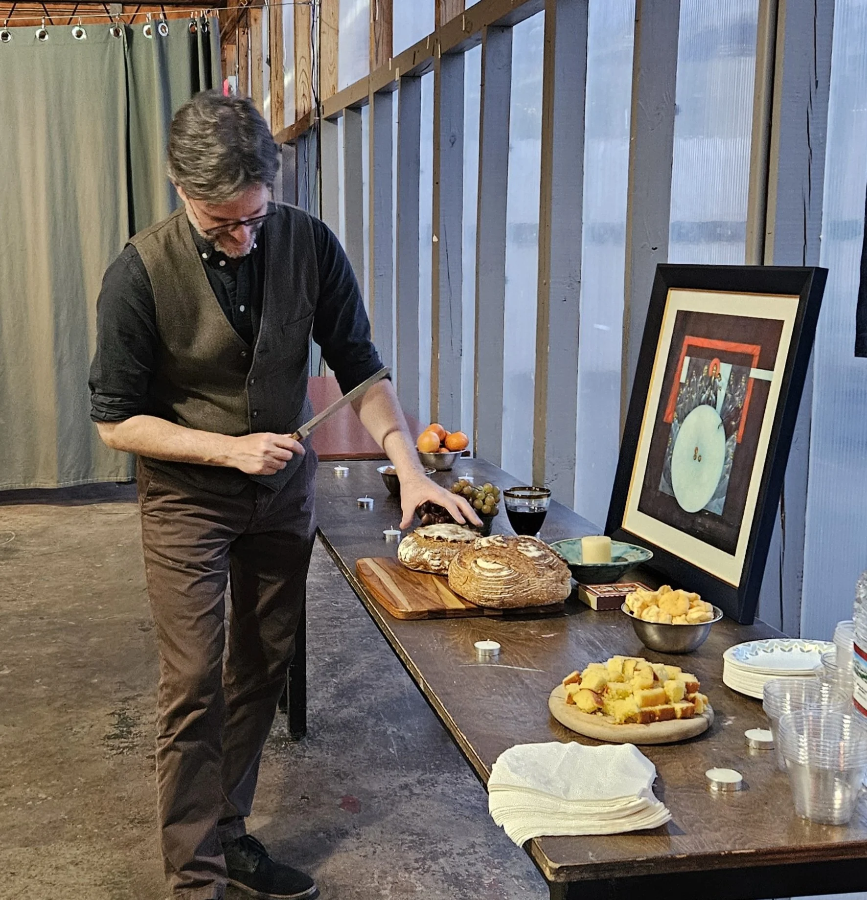 Rev. Patrick cuts the bread he made from scratch!
