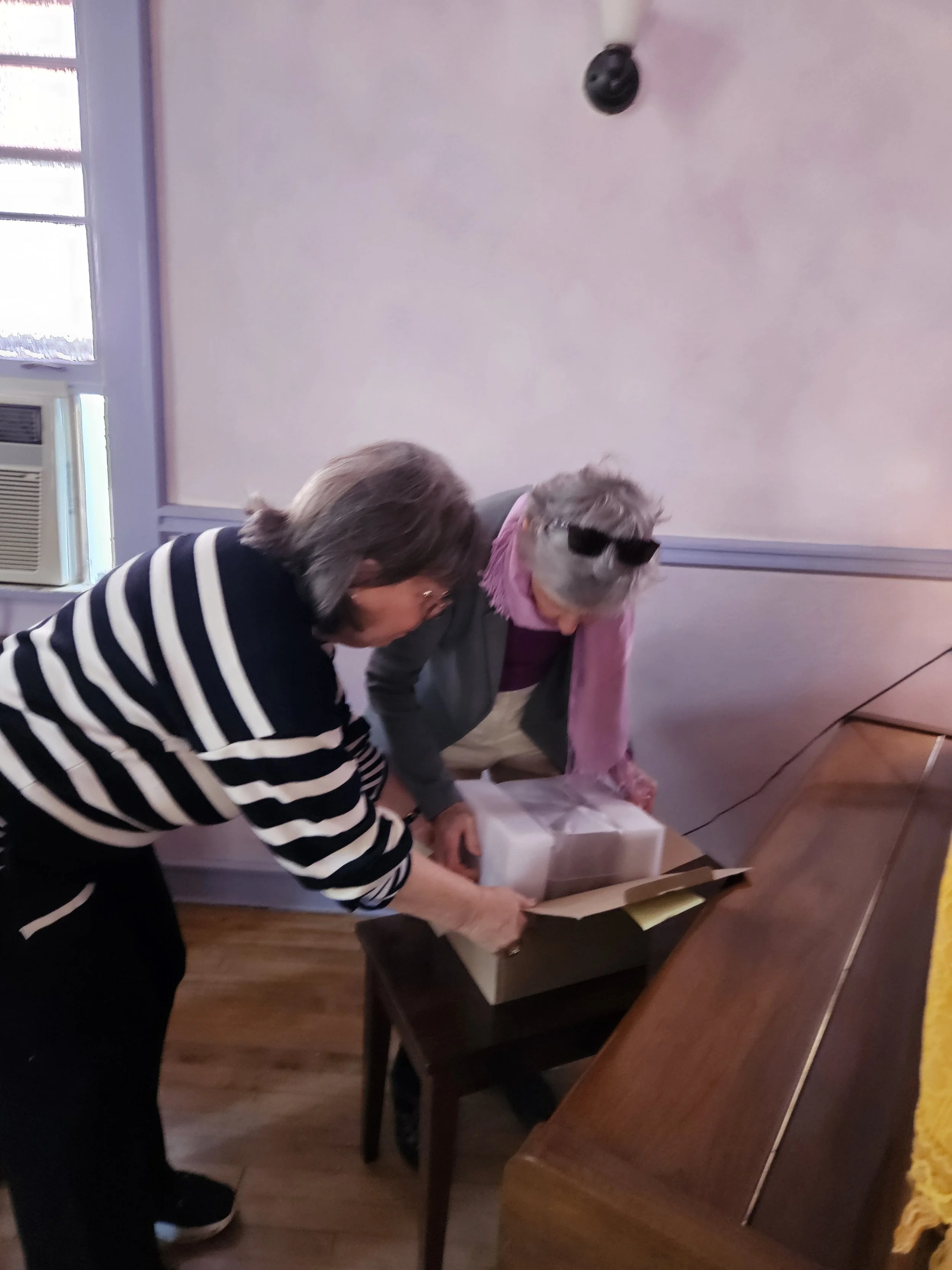 Gail (in Chicago) helps unwrap the rose quartz baptismal vessels lovely crafted by Paul Bloom and Karen Mattison in Viroquoa, WI